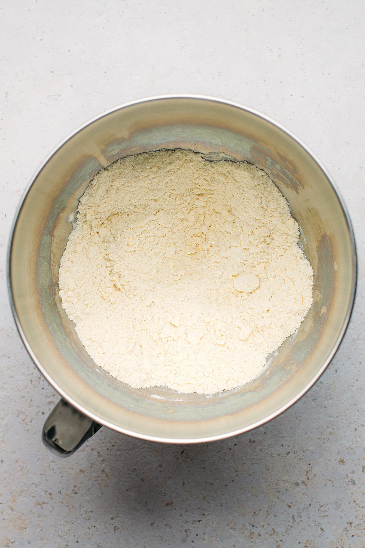 Flour mixed with butter in a stand mixer.