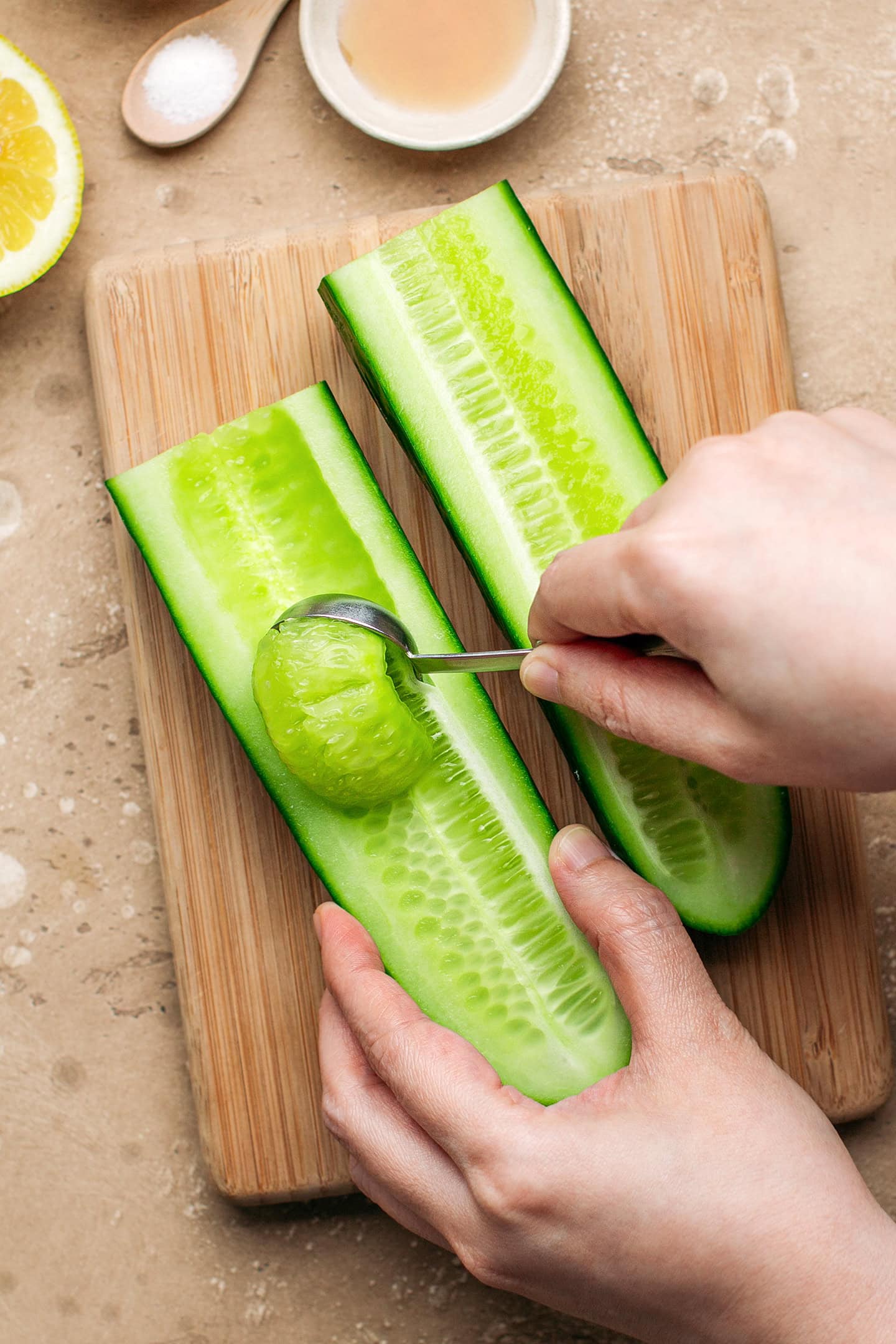 Scooping out the seeds from a cucumber.