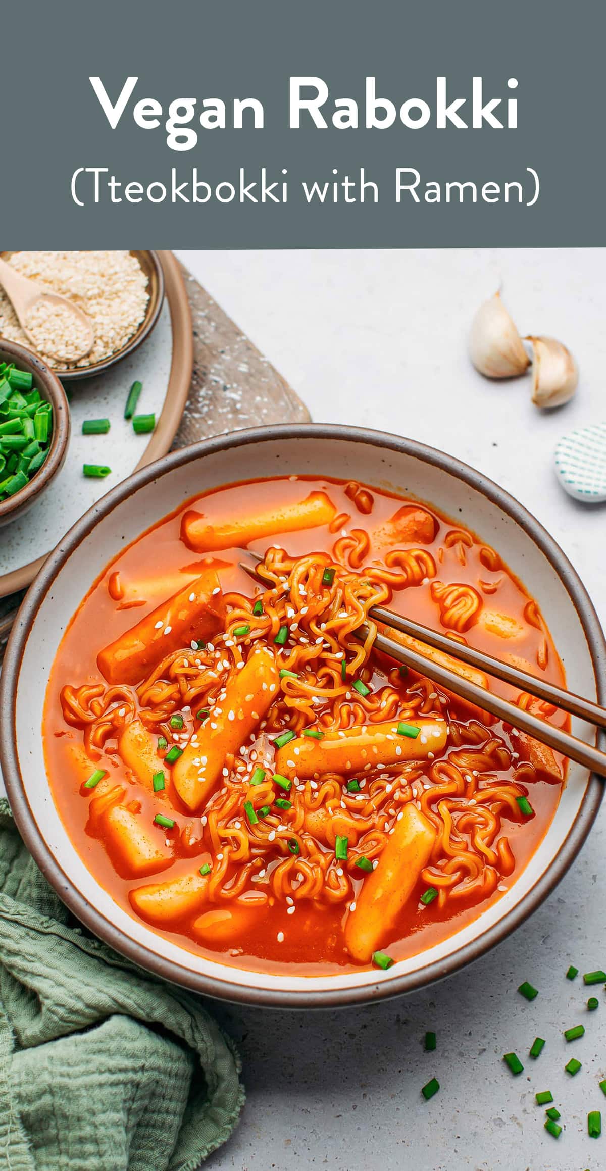 Rabokki is a popular Korean street food that combines Tteokbokki and ramen noodles! This vegan recipe features chewy rice cakes and instant ramen noodles cooked in a creamy and spicy Gochujang sauce. It's saucy, warming, and so hearty! #rabokki #tteokbokki