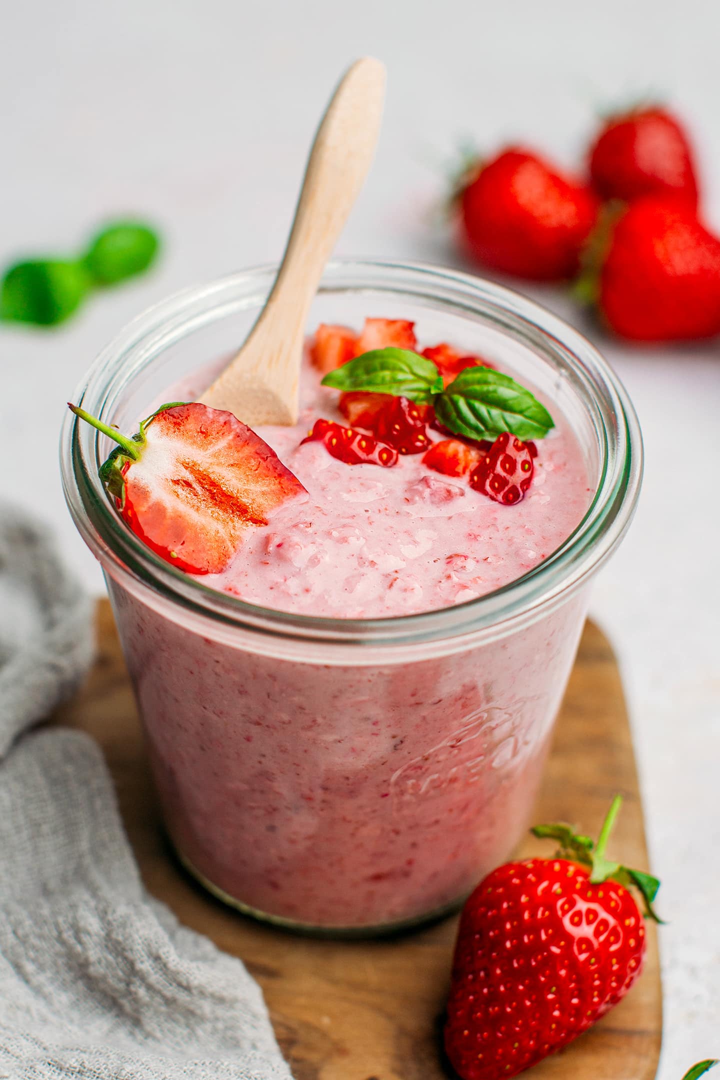 Overnight oats with strawberries in a glass jar.