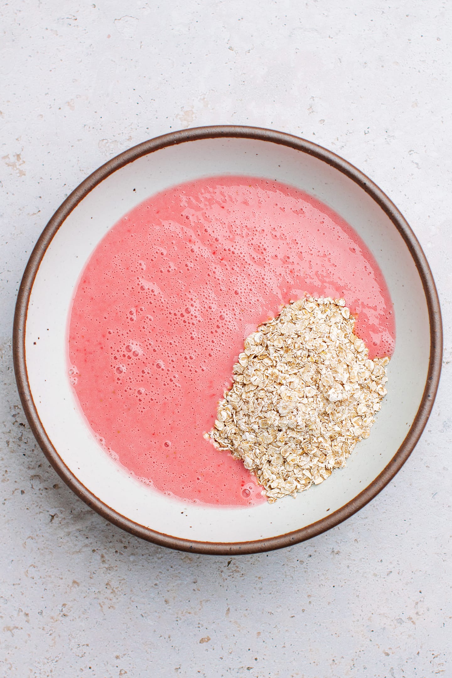 Blended strawberries and oats in a mixing bowl.