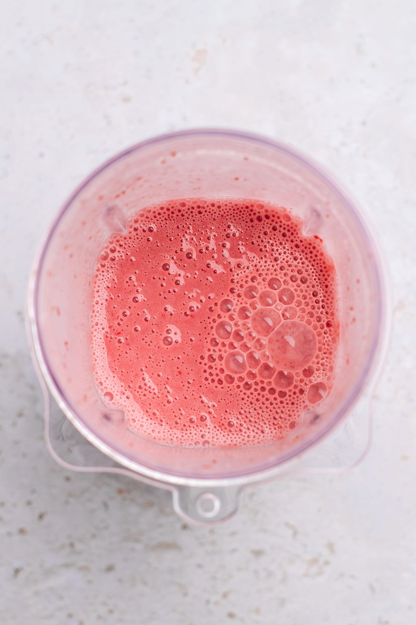 Blended strawberries with milk and yogurt in a blender.