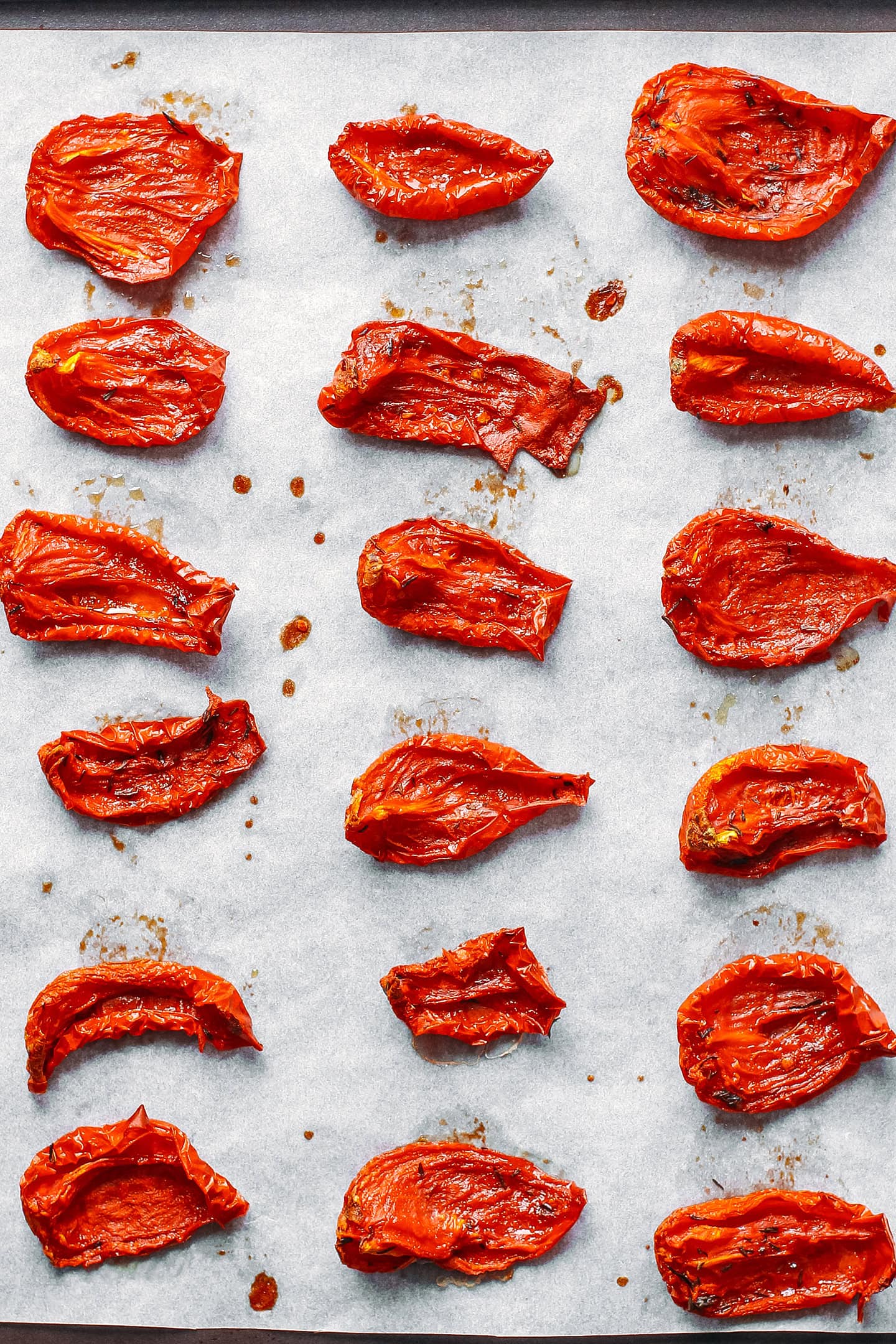 Dried tomatoes on a baking sheet.