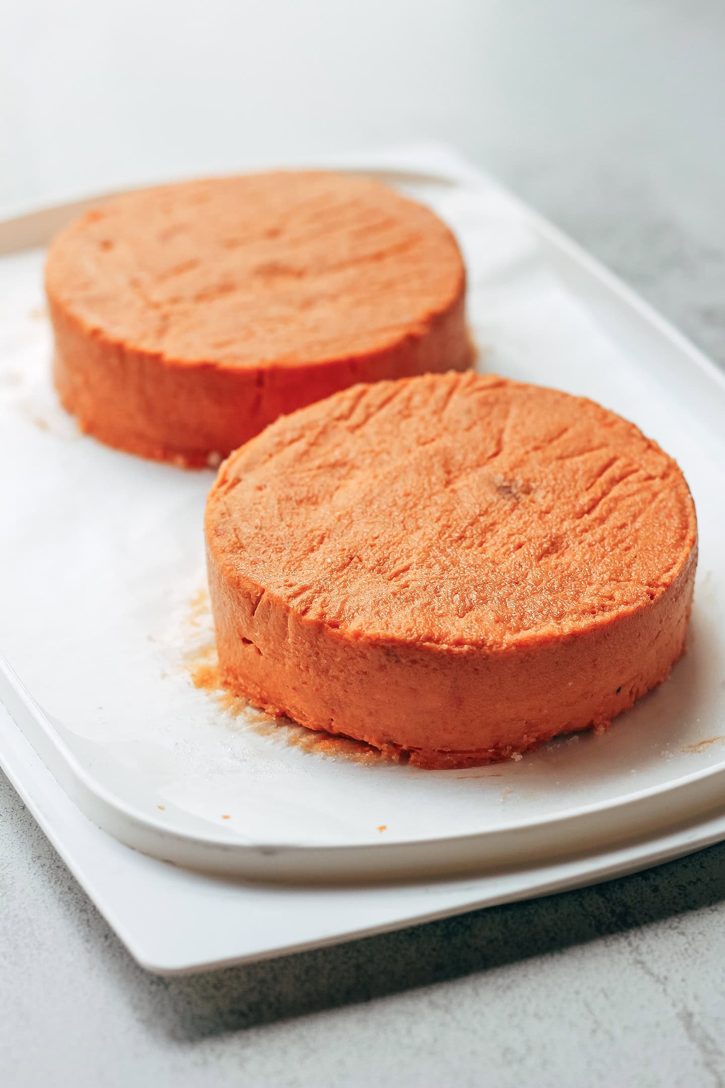 Wheels of sun-dried tomato camembert on parchment paper.