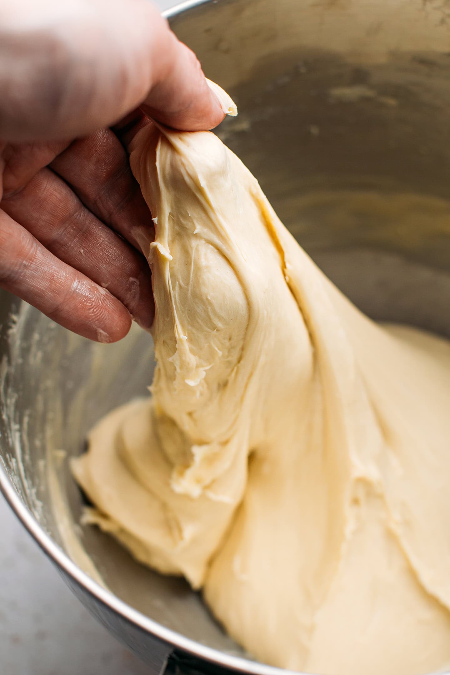 Holding a piece of briocje dough.