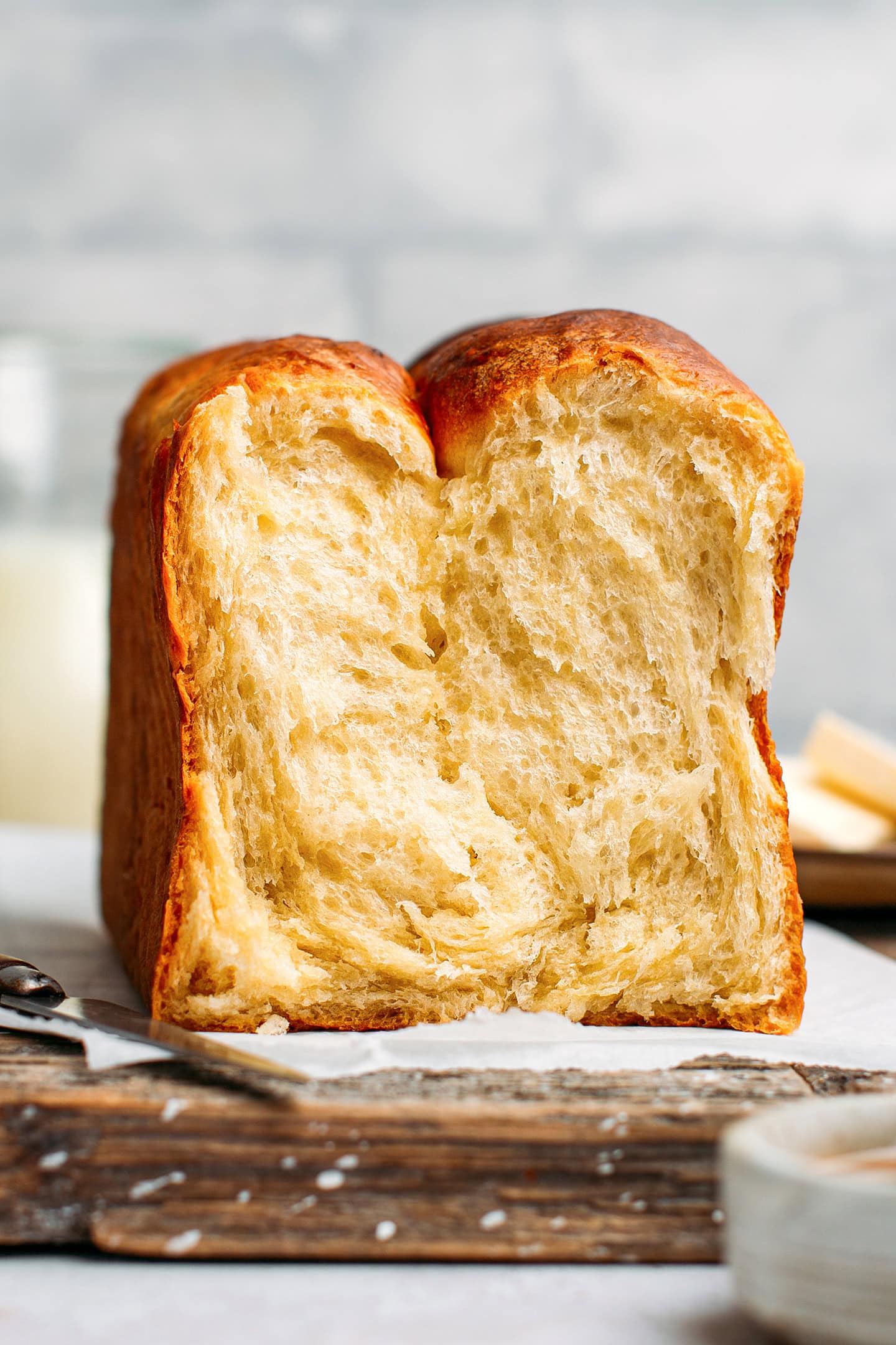 Fluffy vegan brioche on a wood cutting board.