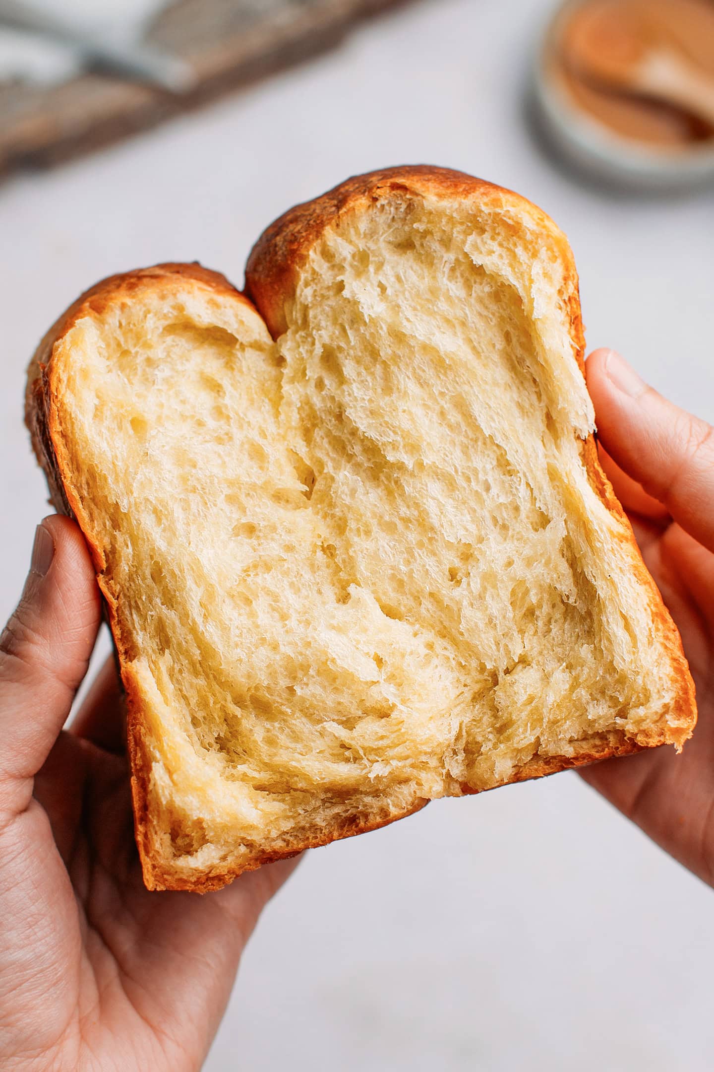 Holding a slice of vegan brioche.