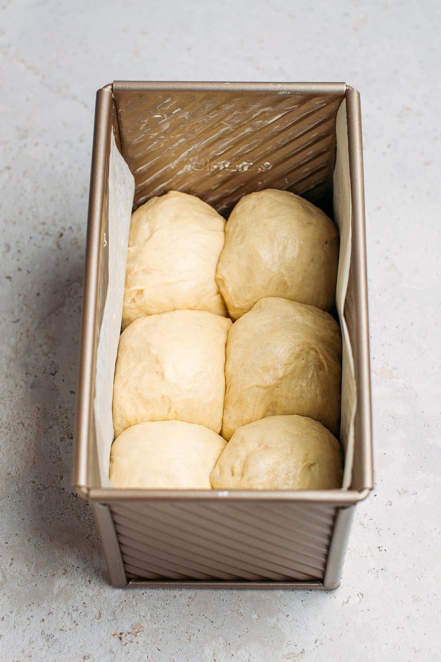 Balls of dough in a pan.