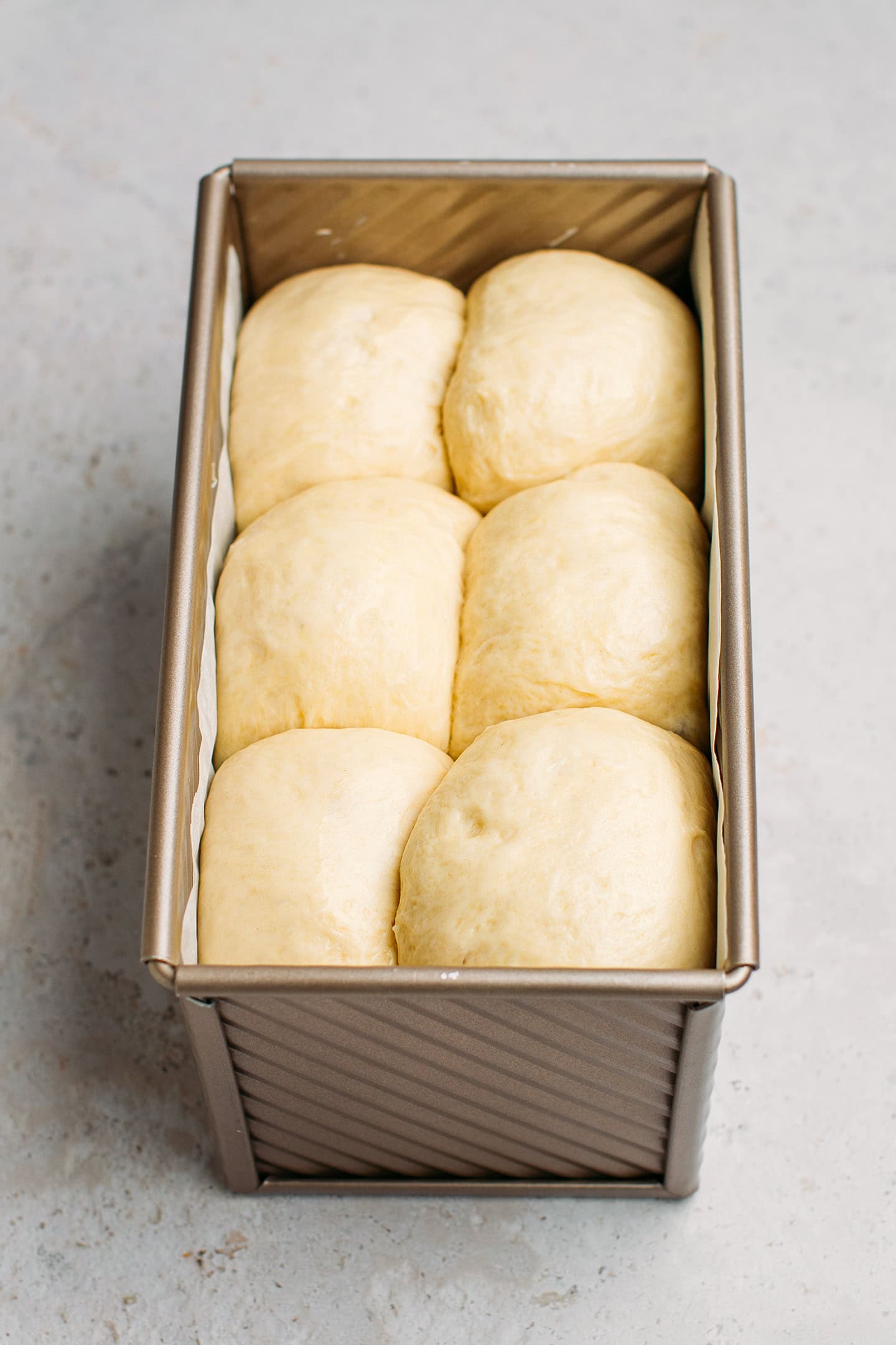 Brioche dough in a rectangular pan.