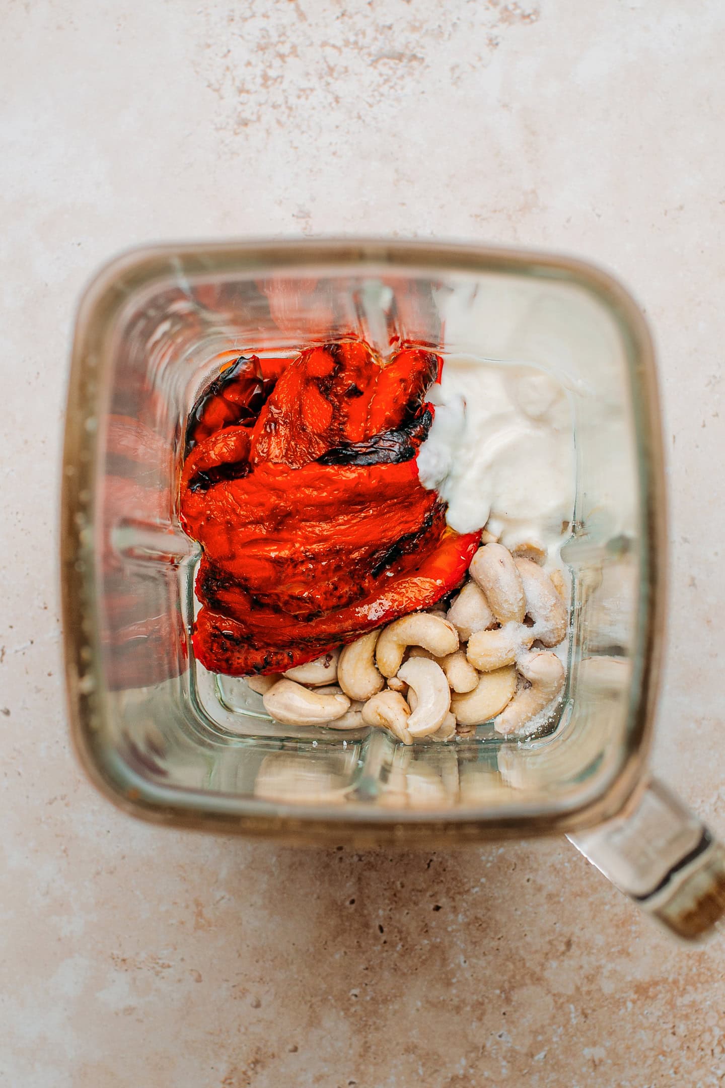 Roasted red bell pepper, cashews, and yogurt in a blender.