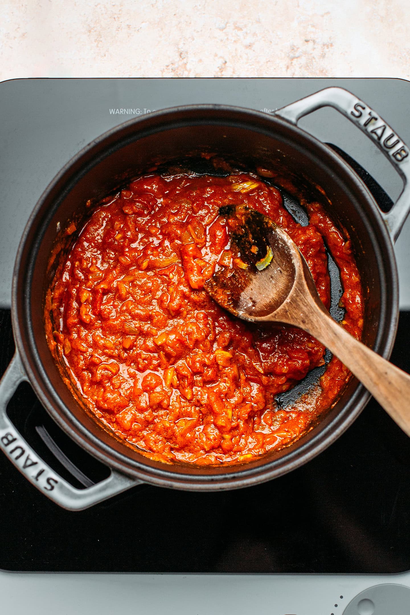 Cooked tomatoes and spices in a pot.