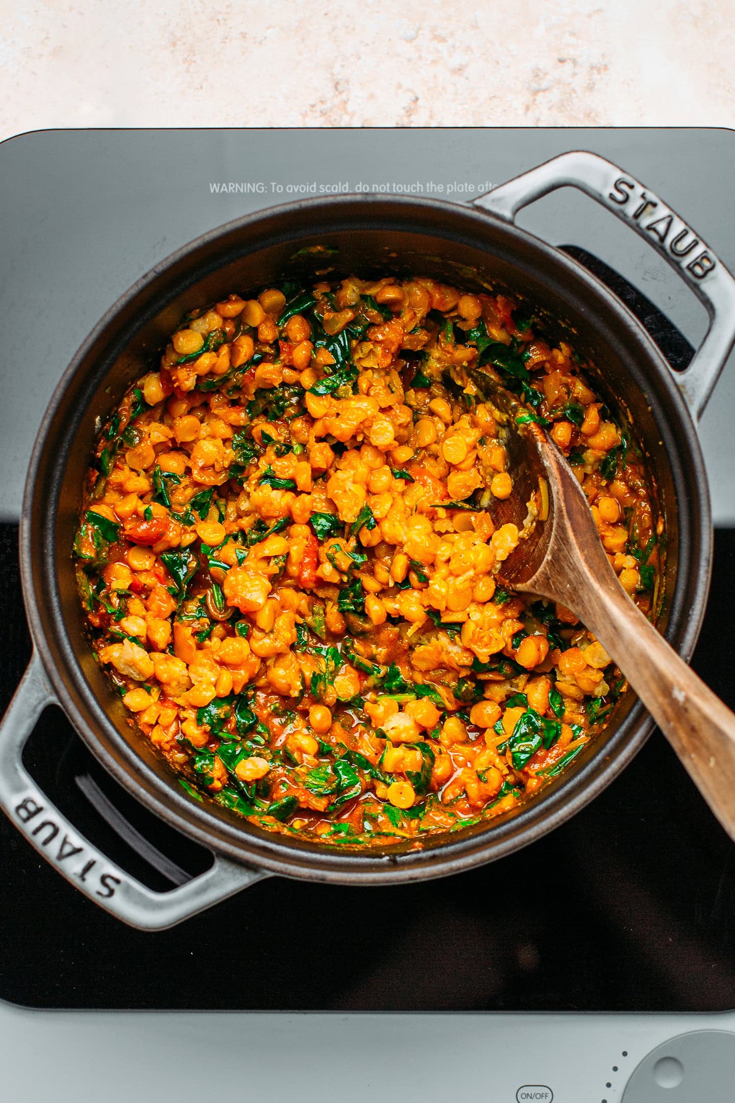 Chana dal and spinach in a deep pot.