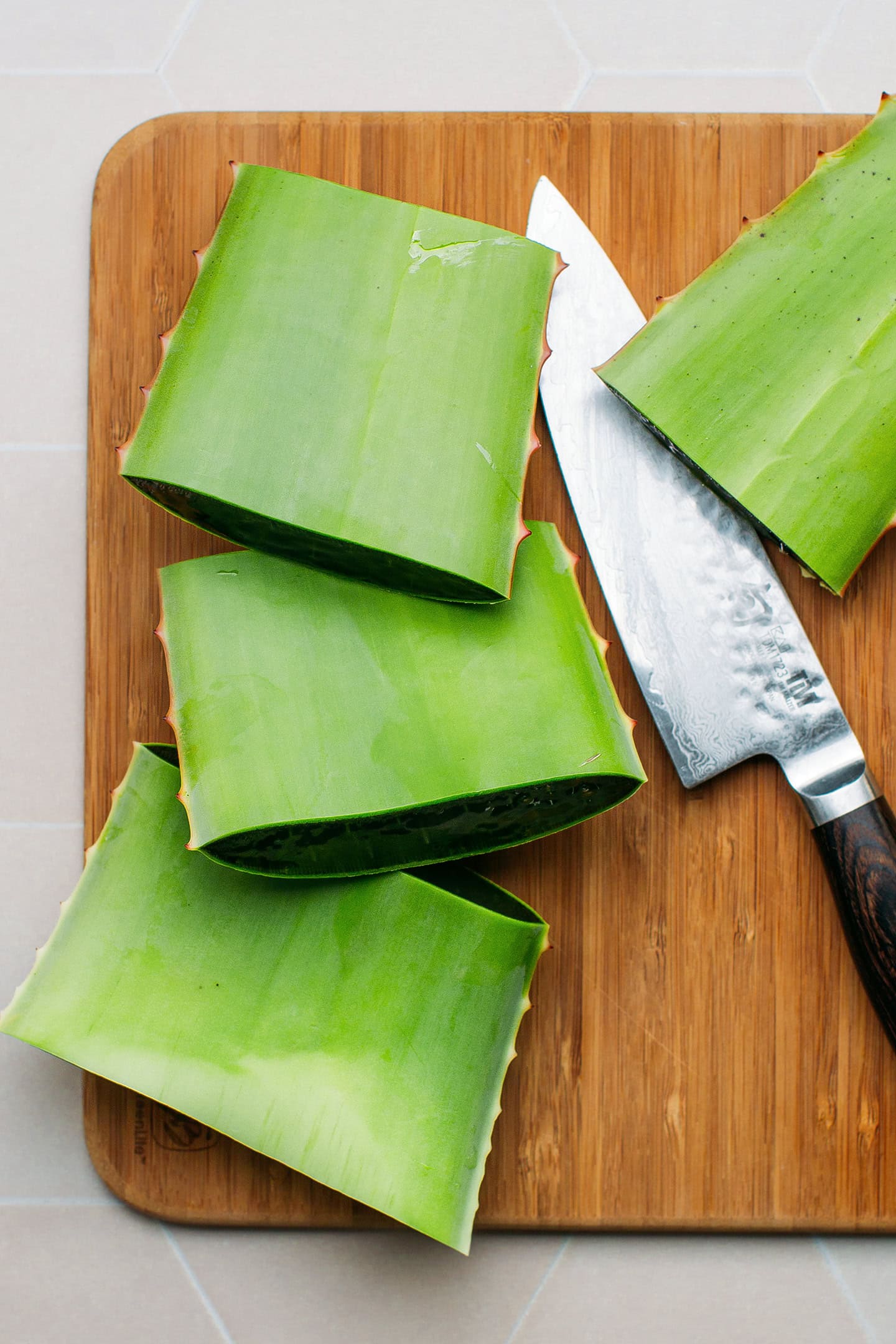 Sliced aloe vera on a cutting board.