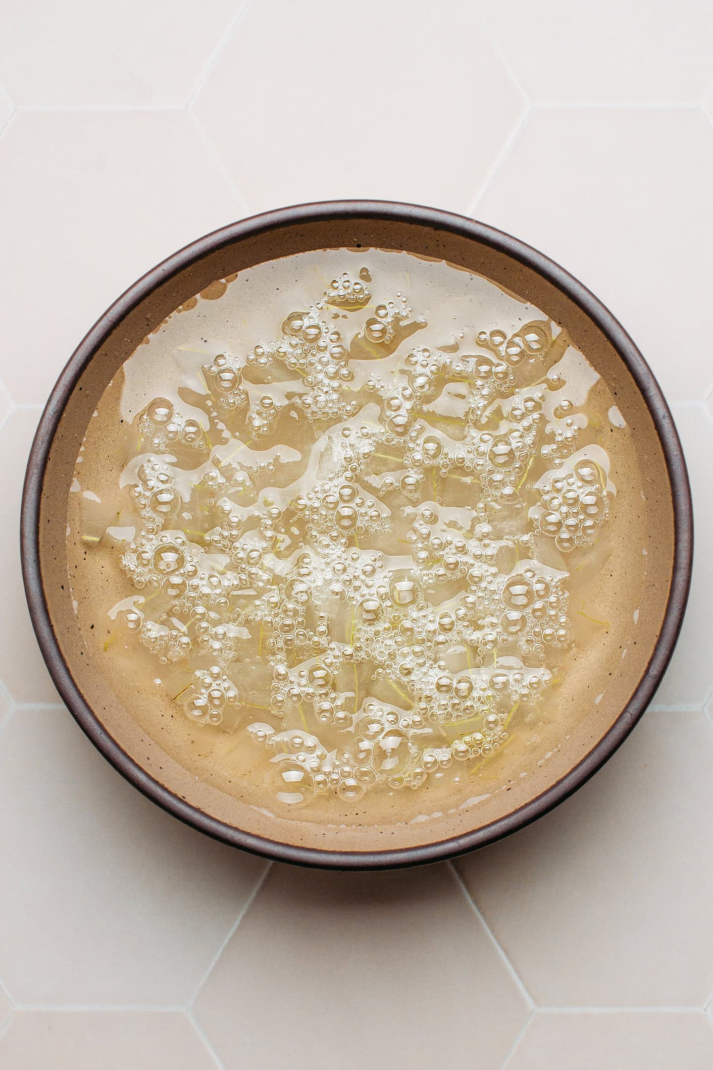 Diced aloe vera soaking in a bowl of water.