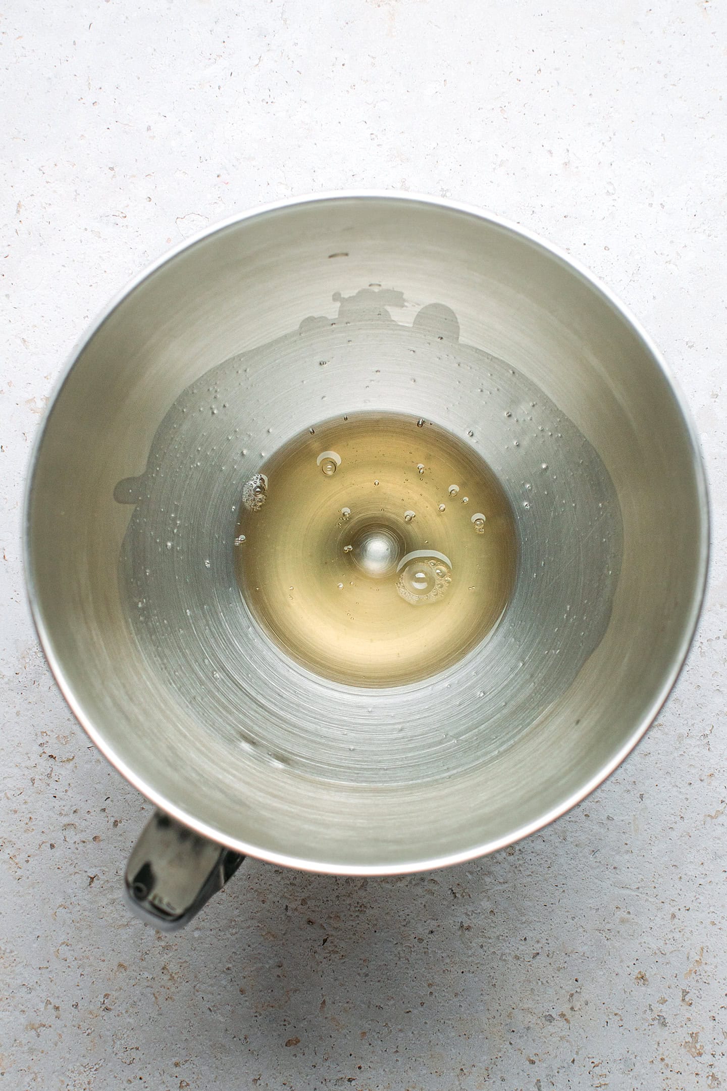 Aquafaba in the bowl of a stand mixer.