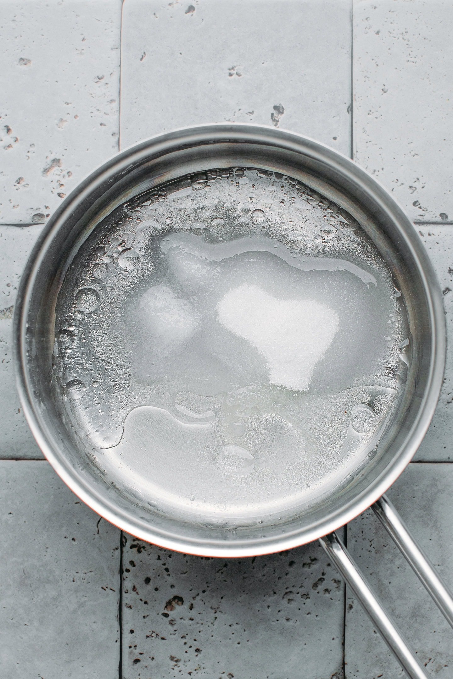 Sugar, salt, and water in a saucepan.