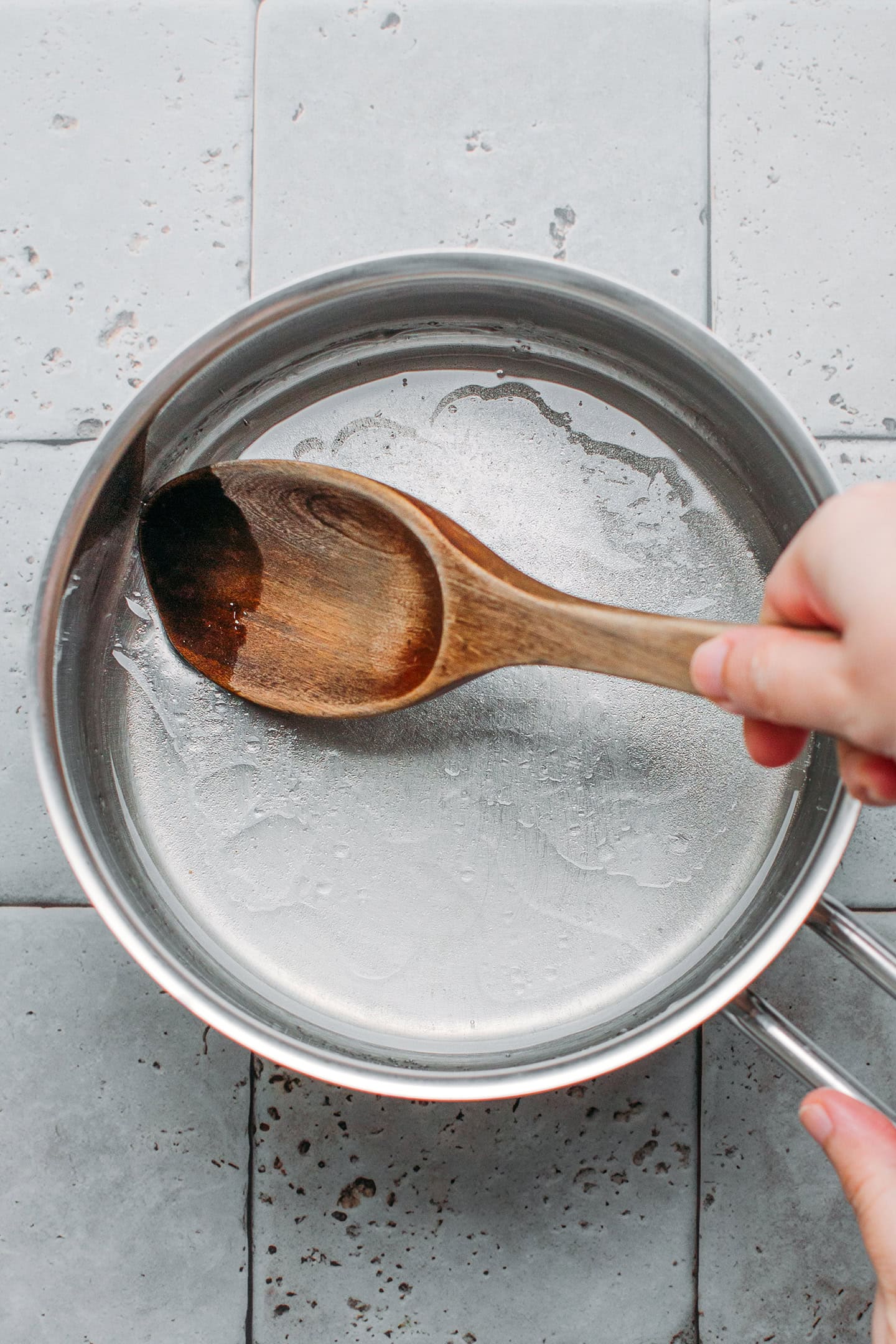 Stirring syrup in a saucepan.