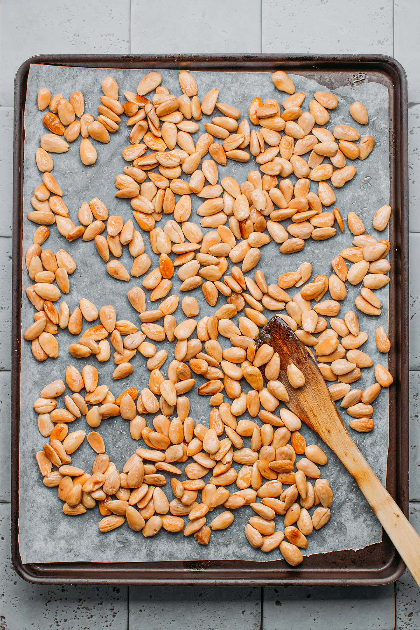 Roasted almonds on a baking sheet.