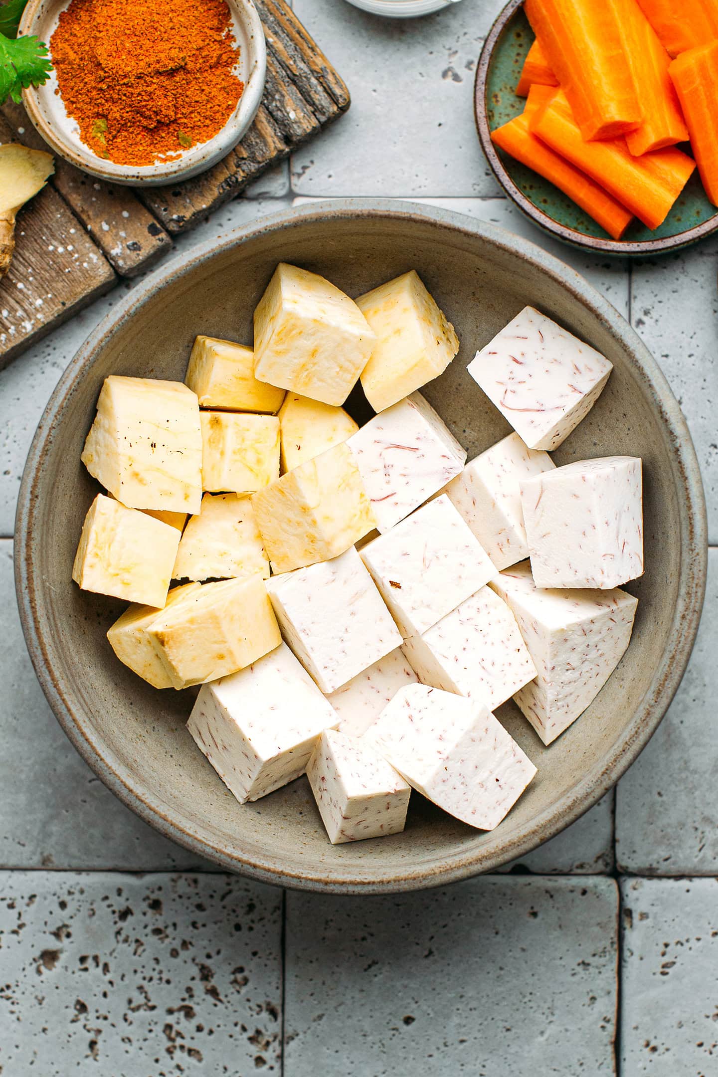 Taro and sweet potatoes in a bowl.