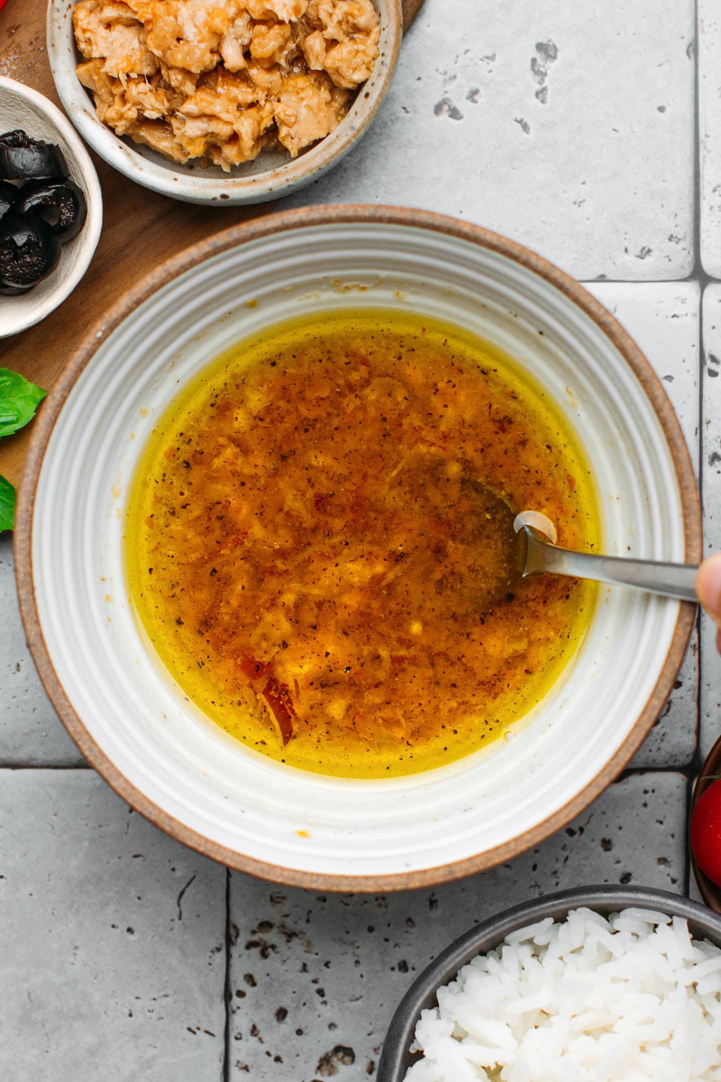 Stirring vinaigrette in a small bowl.