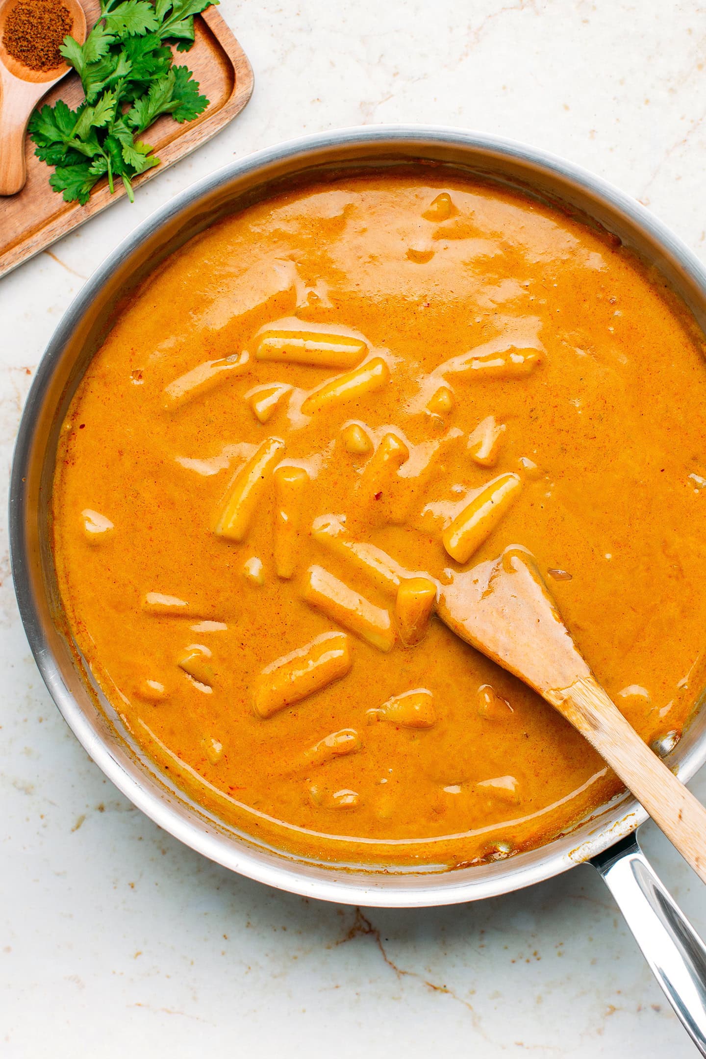 Tteokbokki in a curry sauce in a skillet.