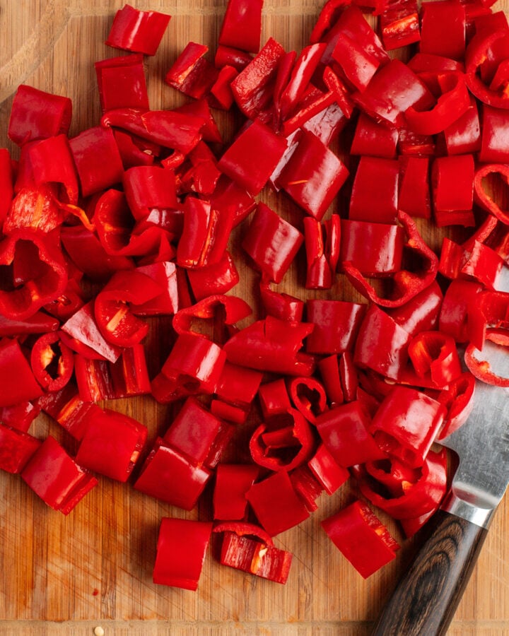Chopped cayenne peppers on a cutting board.