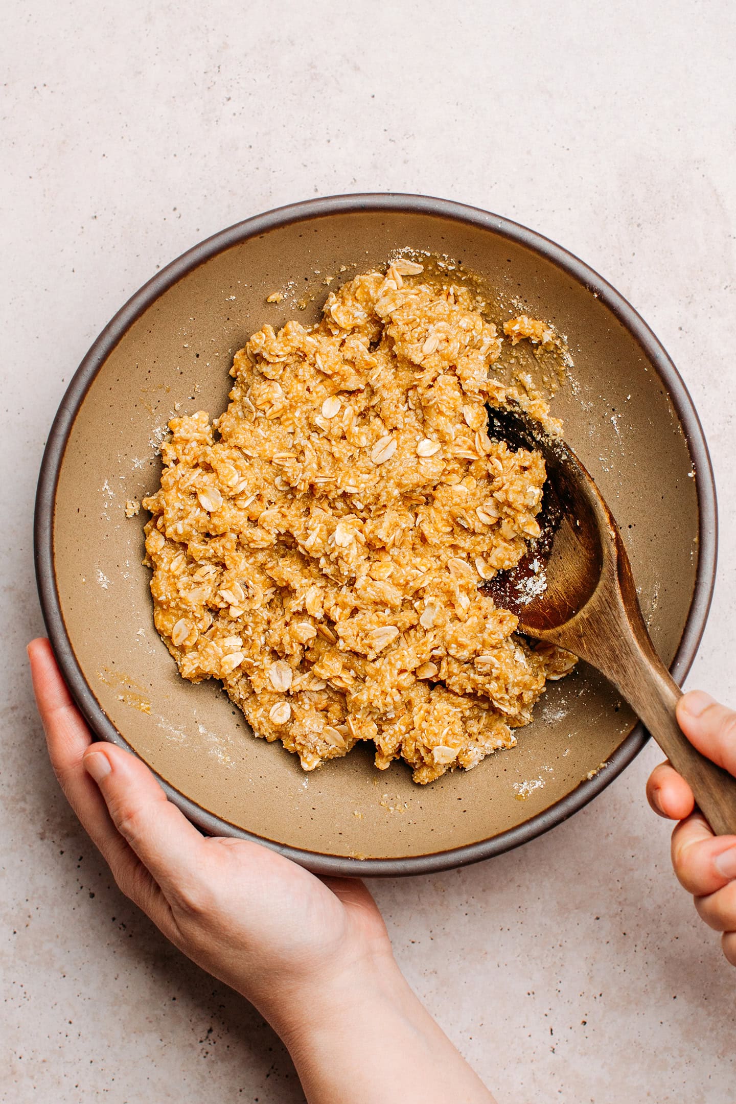 Oat and coconut cookie batter in a bowl.