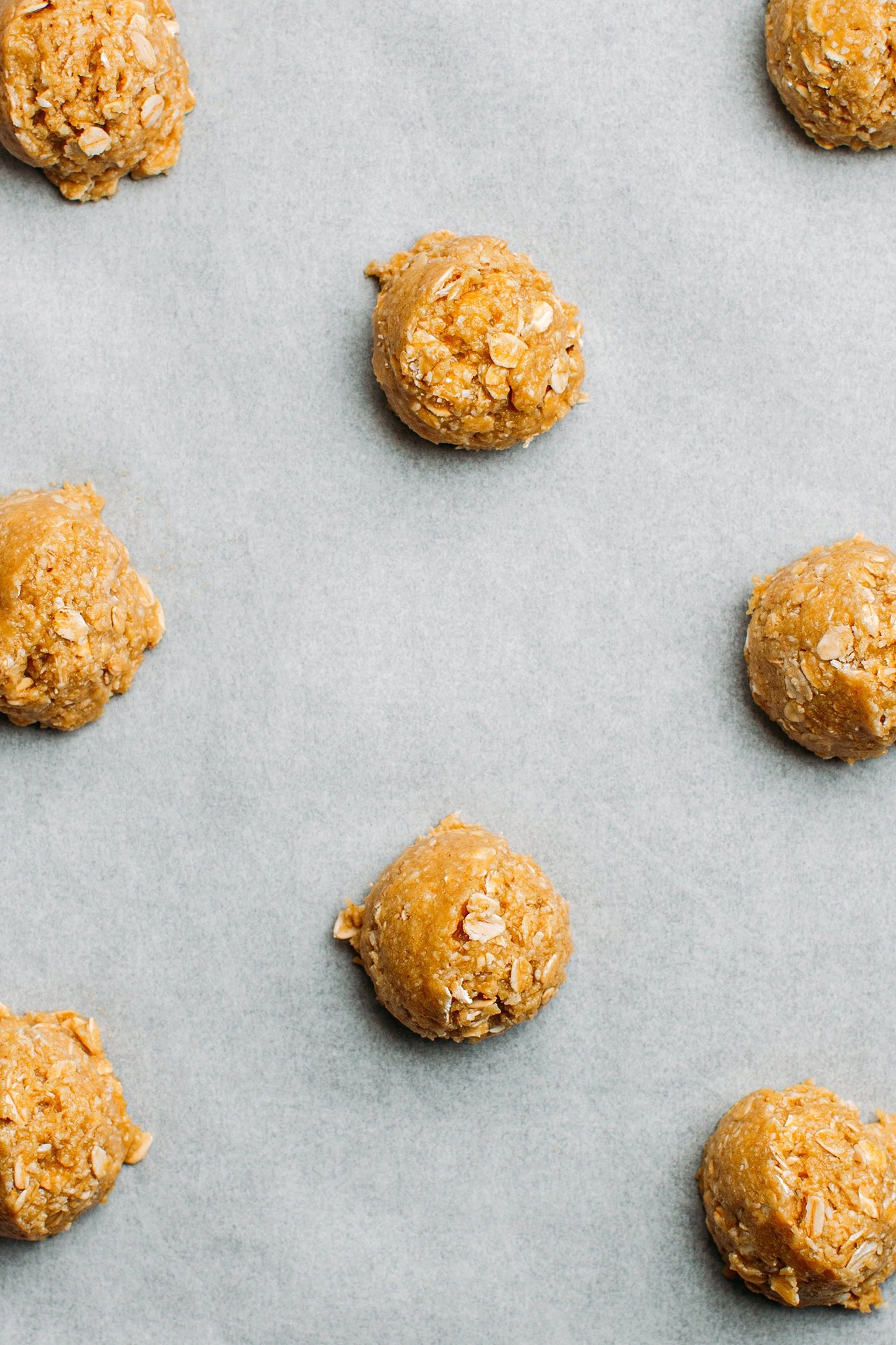 Balls of cookie dough on a baking sheet.