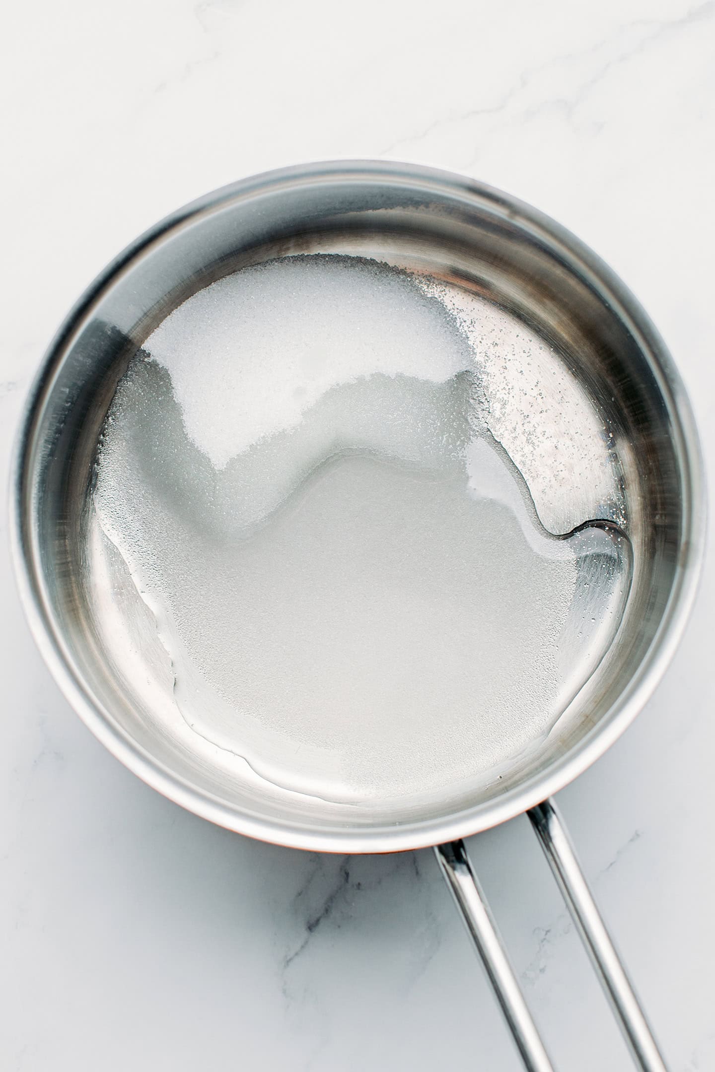 Sugar and water in a saucepan.