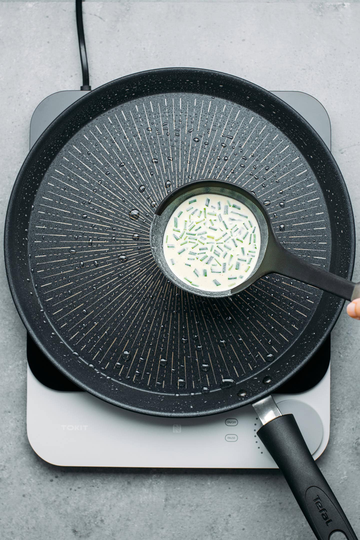 Pouring a batter into a non-stick pan.