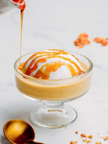 Pouring salted caramel on top of a meringue.