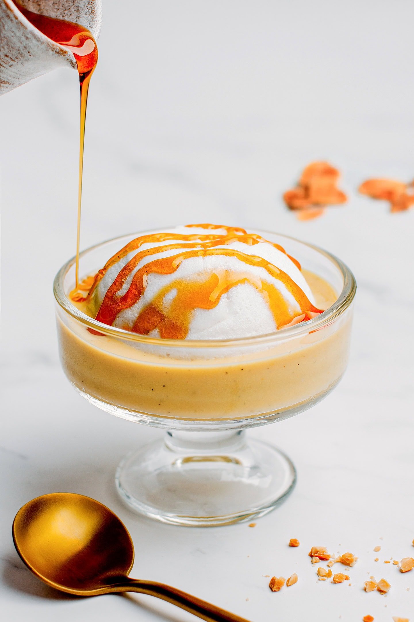 Pouring salted caramel on top of a meringue.