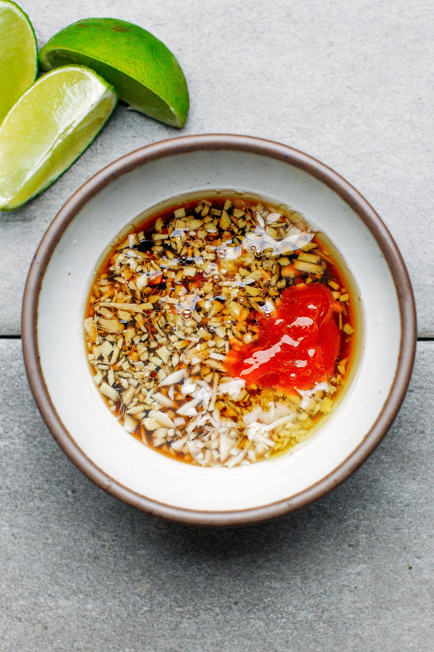 Soy sauce, sriracha, maple syrup, and garlic in a small bowl.