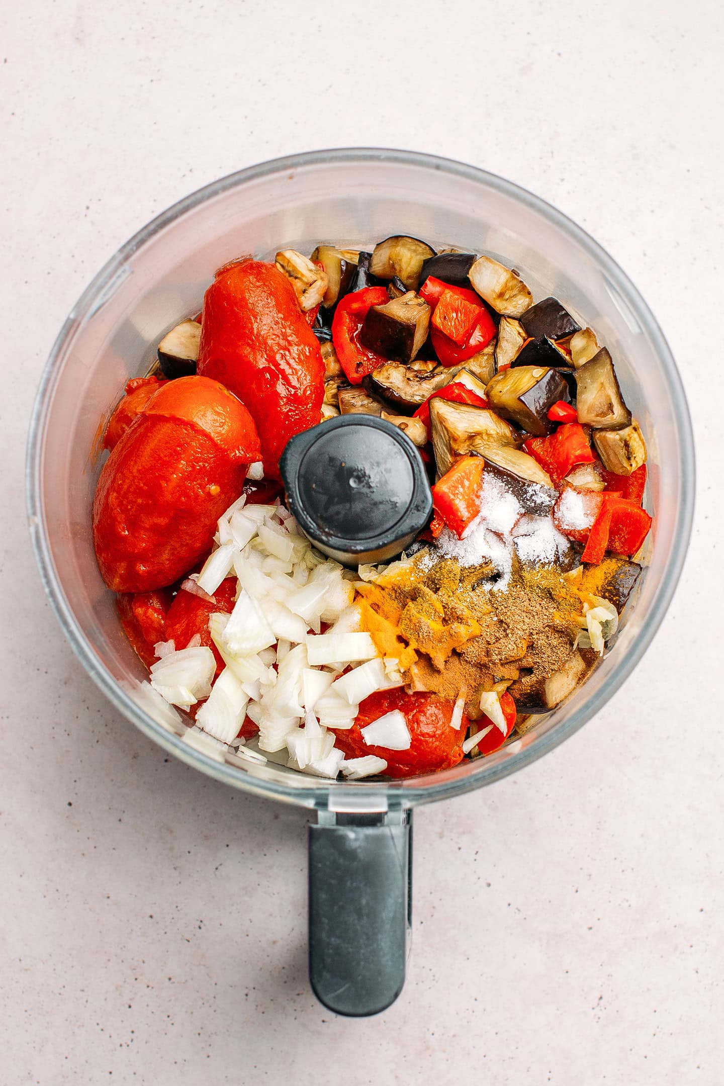 Baked eggplants, bell peppers, tomatoes, and onion in a food processor.