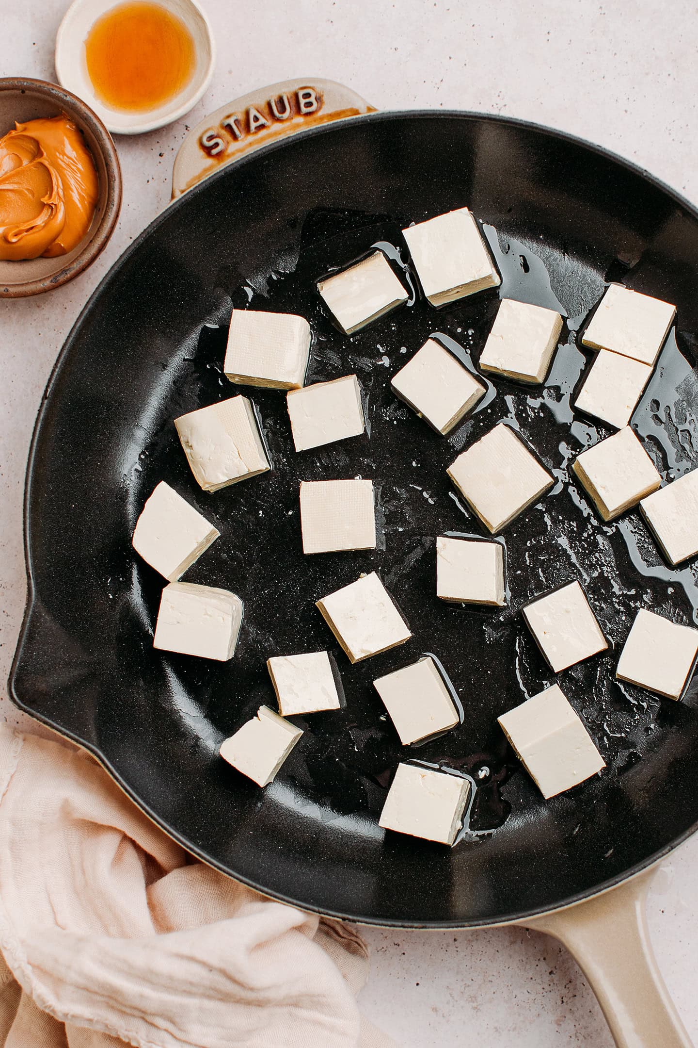 Diced tofu in a pan.