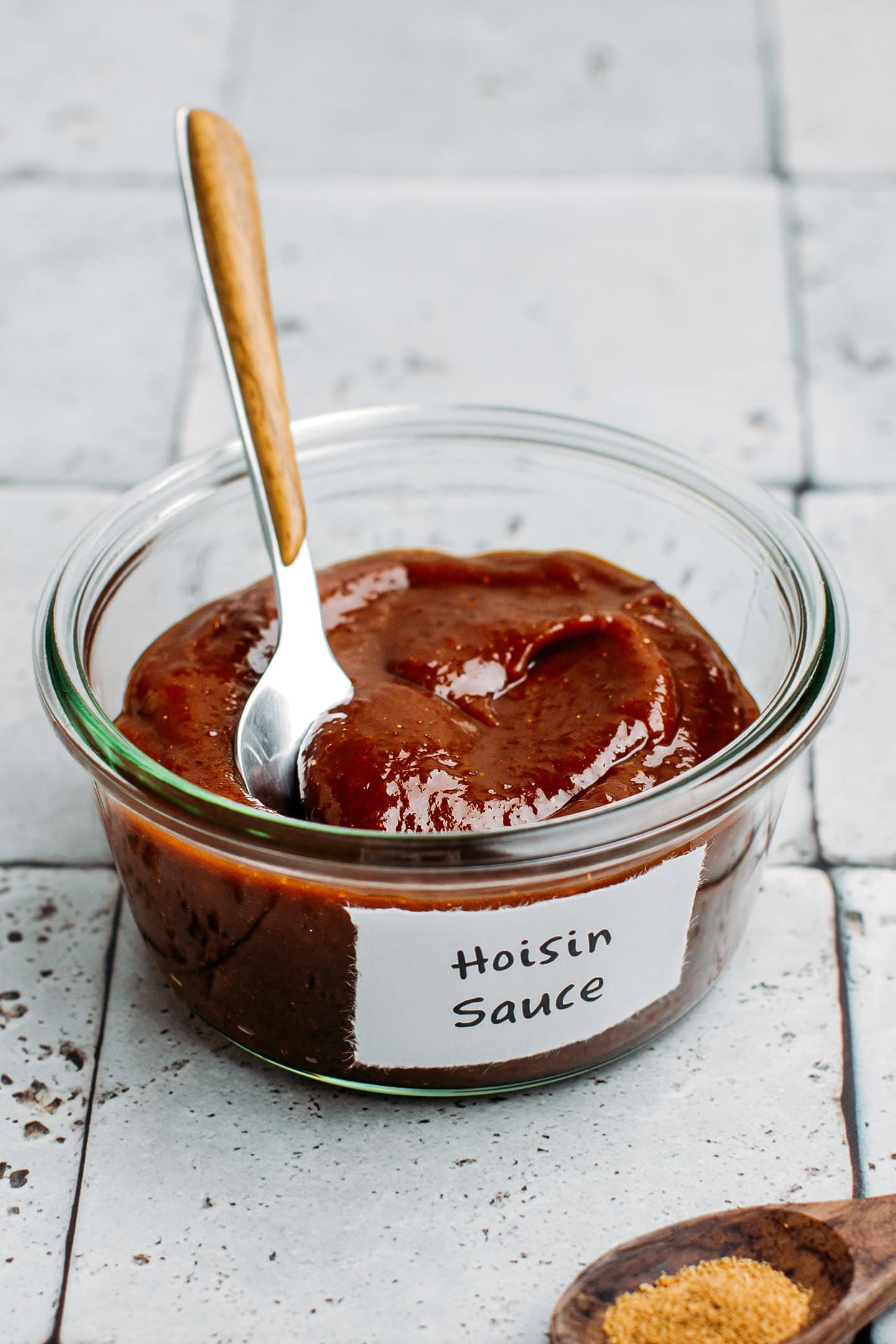 Hoisin sauce in a small glass jar.