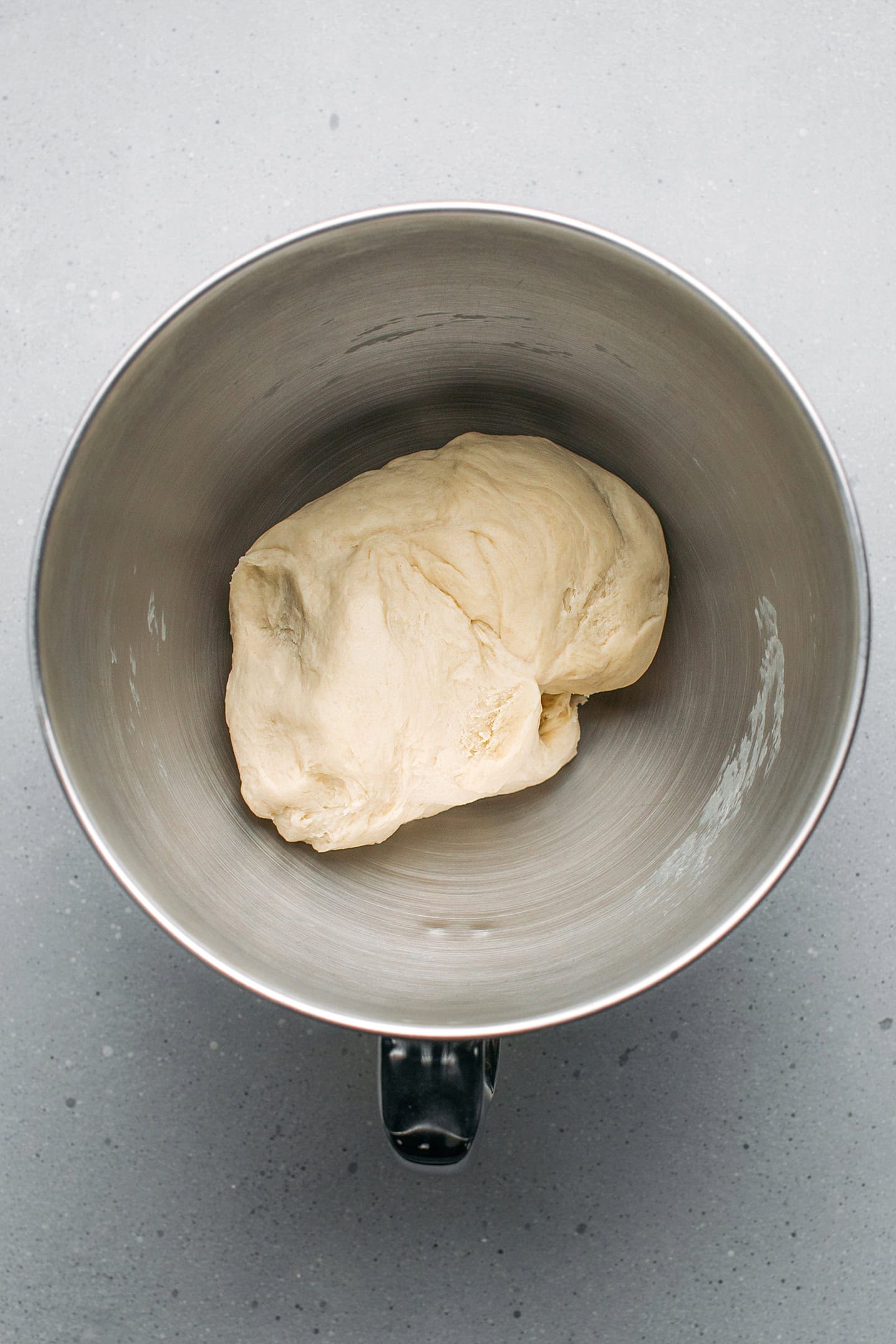 Brioche dough in a stand mixer bowl.