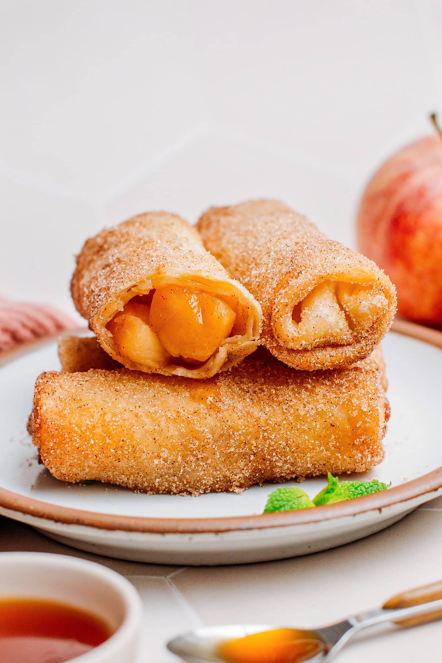 Stack of egg rolls filled with juicy apples.