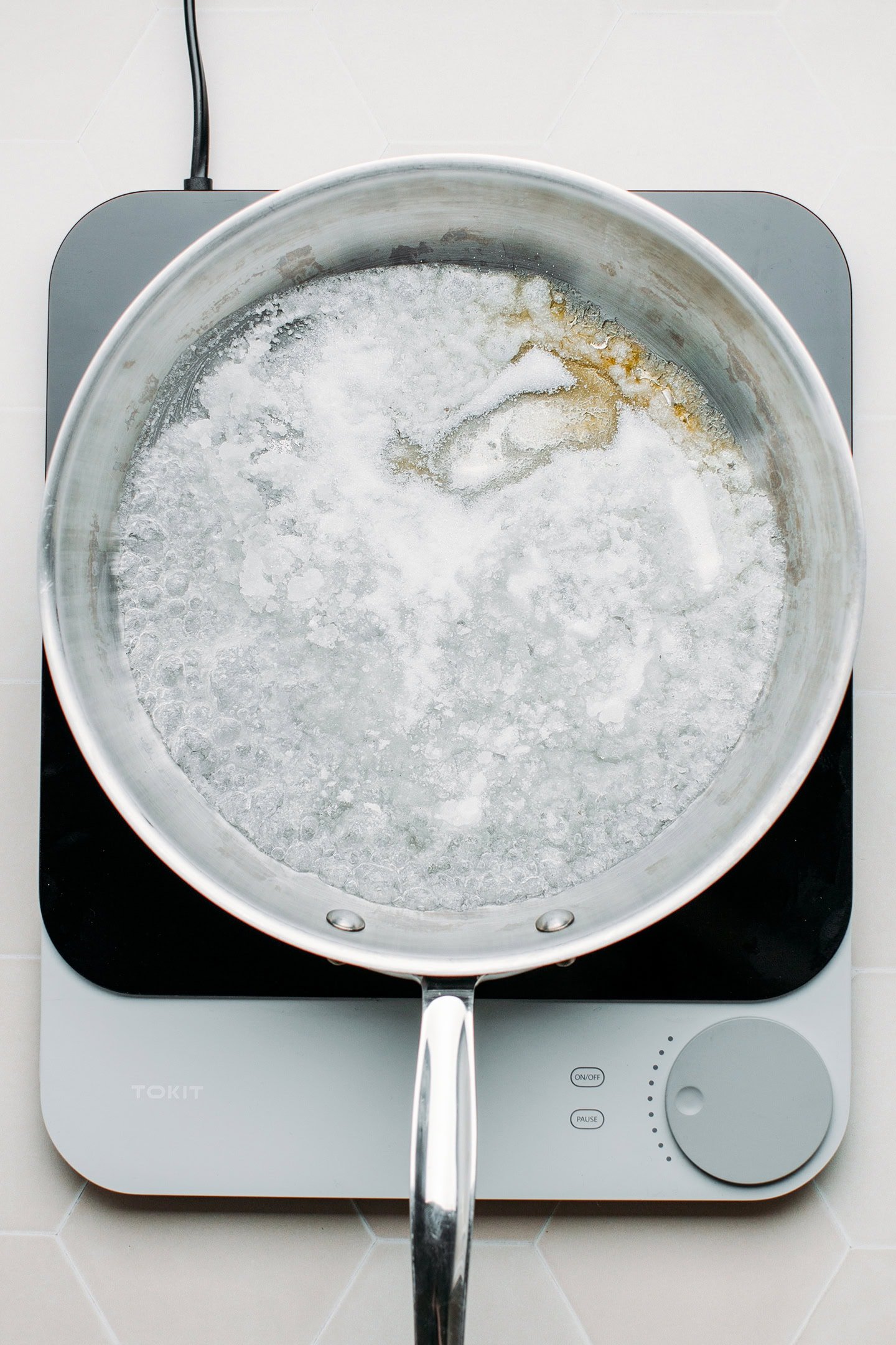 Melting sugar in a pan.