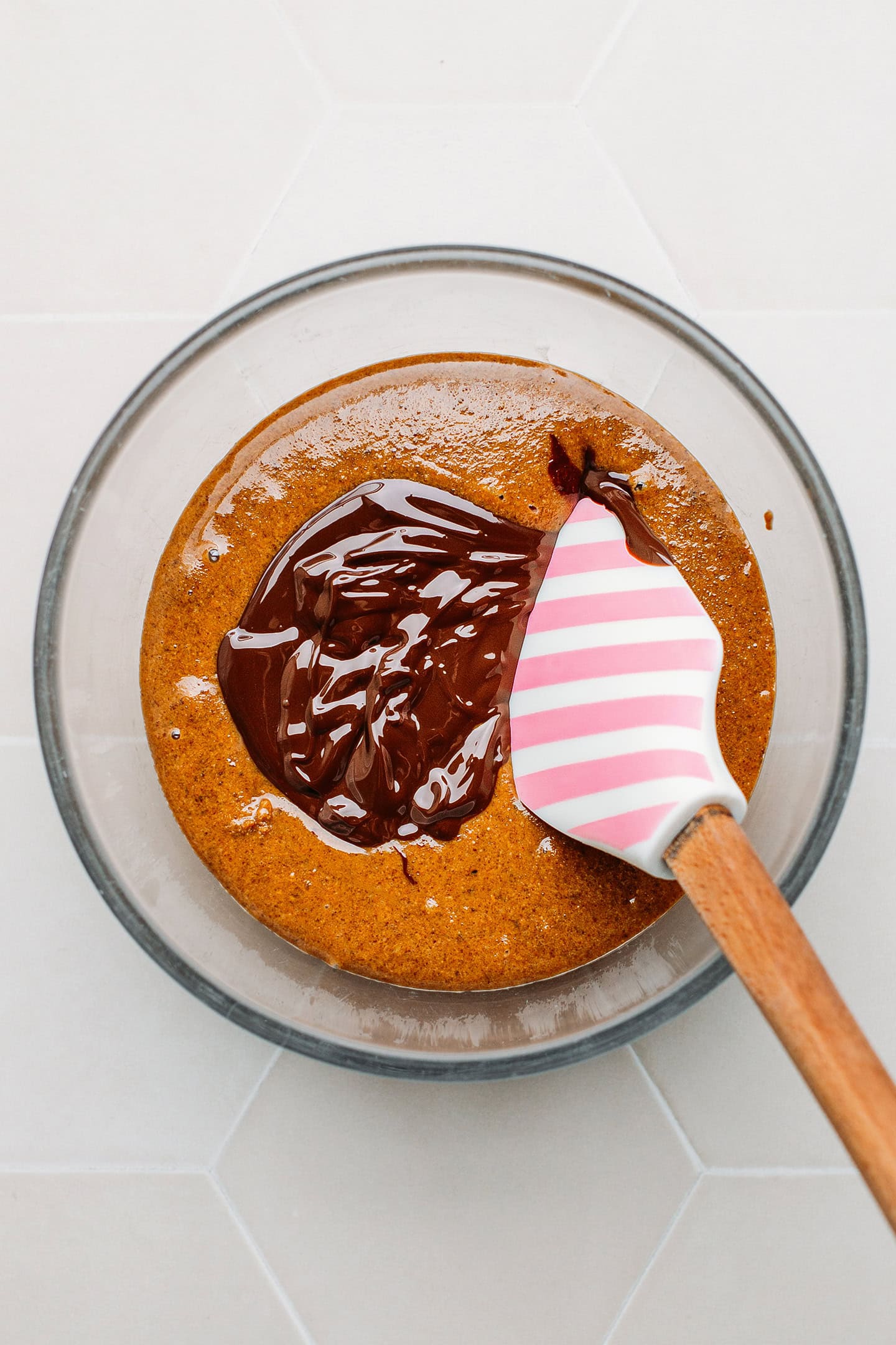 Praline paste and melted chocolate in a mixing bowl.