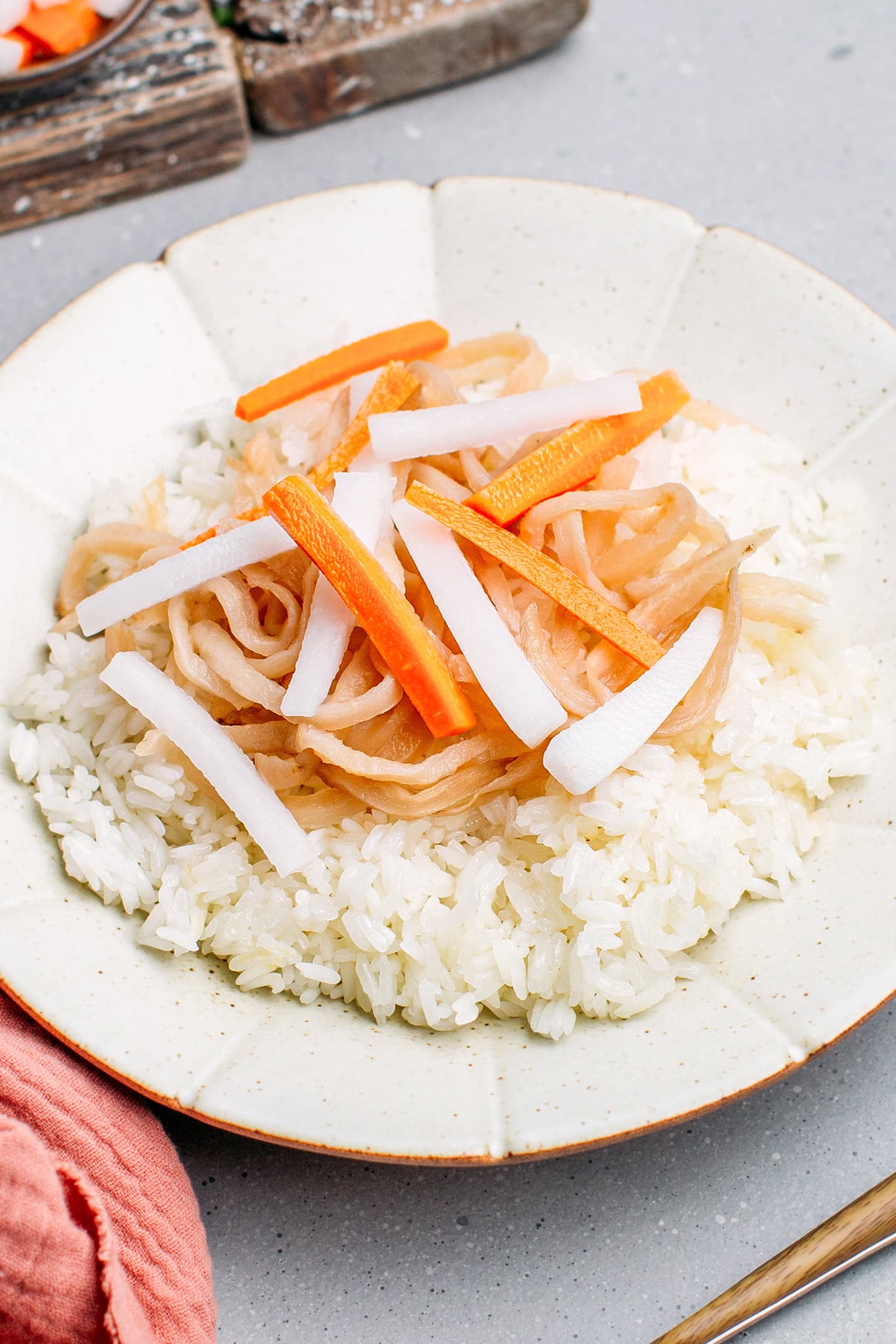 Preserved radish and pickles on top of white rice.