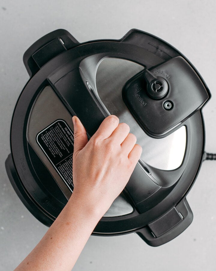 Closing the Instant Pot with its lid.
