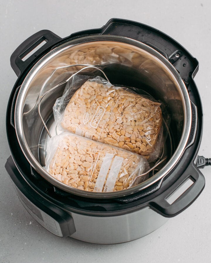Two freeze bags filled with cooked soybeans in an Instant Pot.