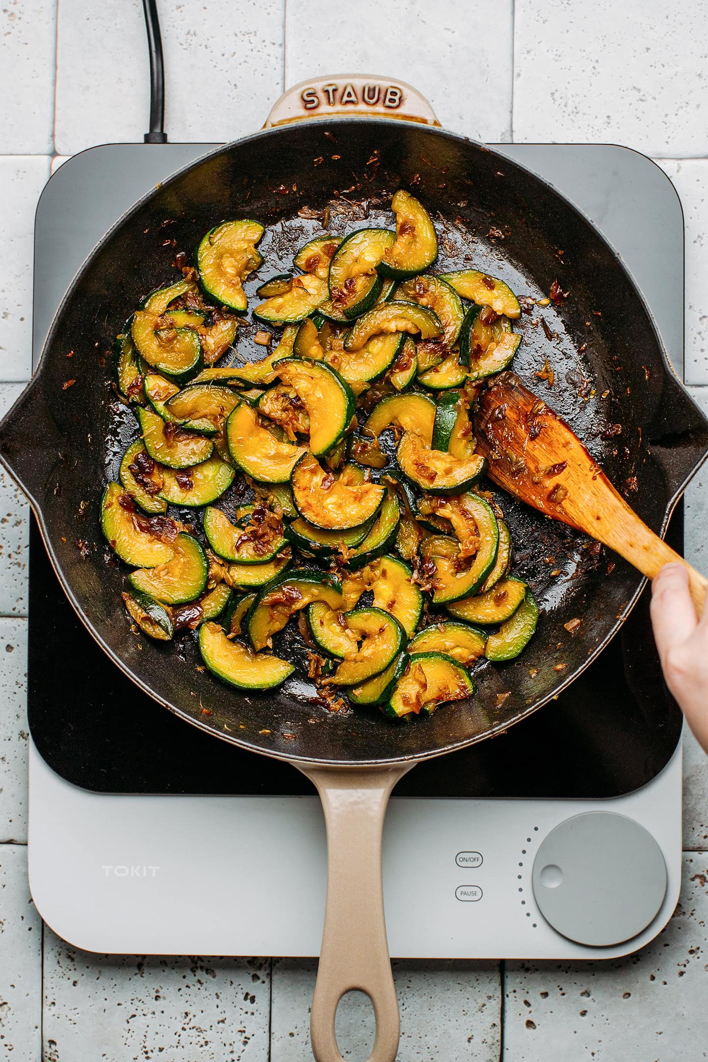 Caramelized zucchini slices in a pan.