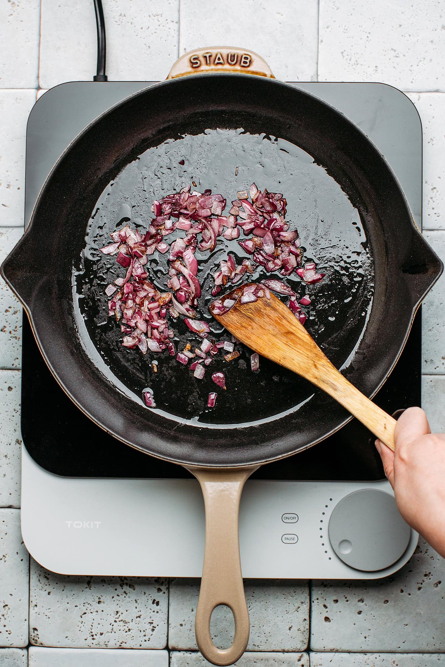 Sautéed diced onion in a pan.