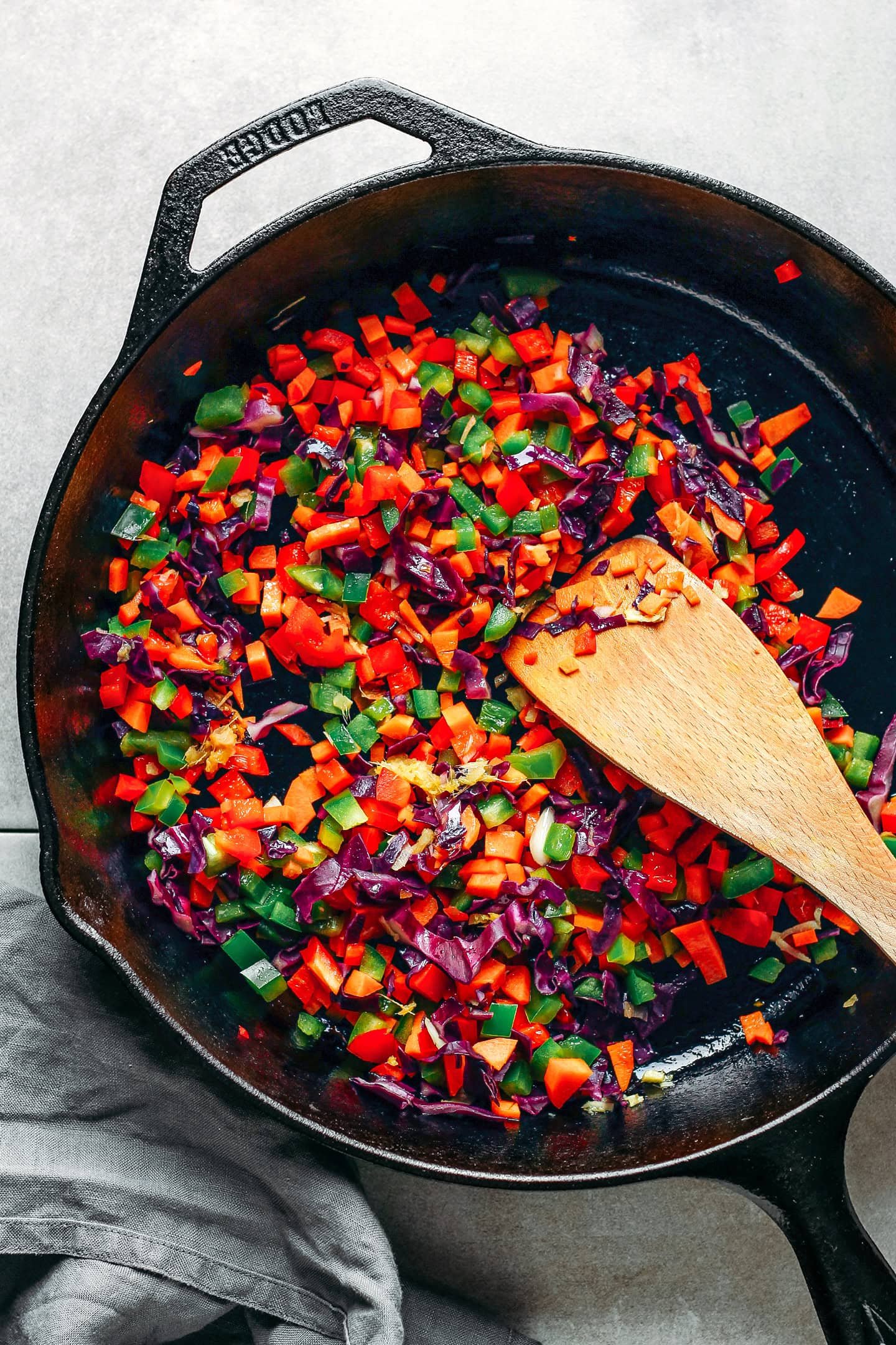 Sautéed diced vegetables in a skillet.