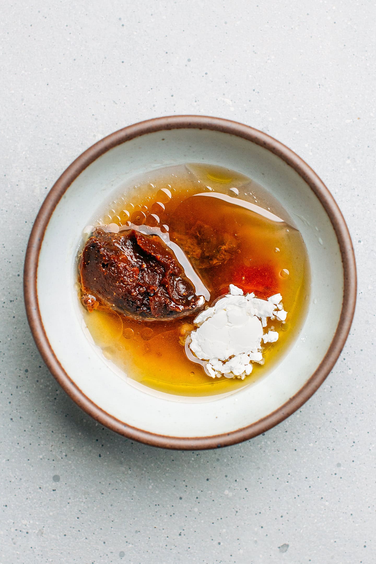 Doenjang paste, sesame oil, sriracha, and cornstarch in a small bowl.