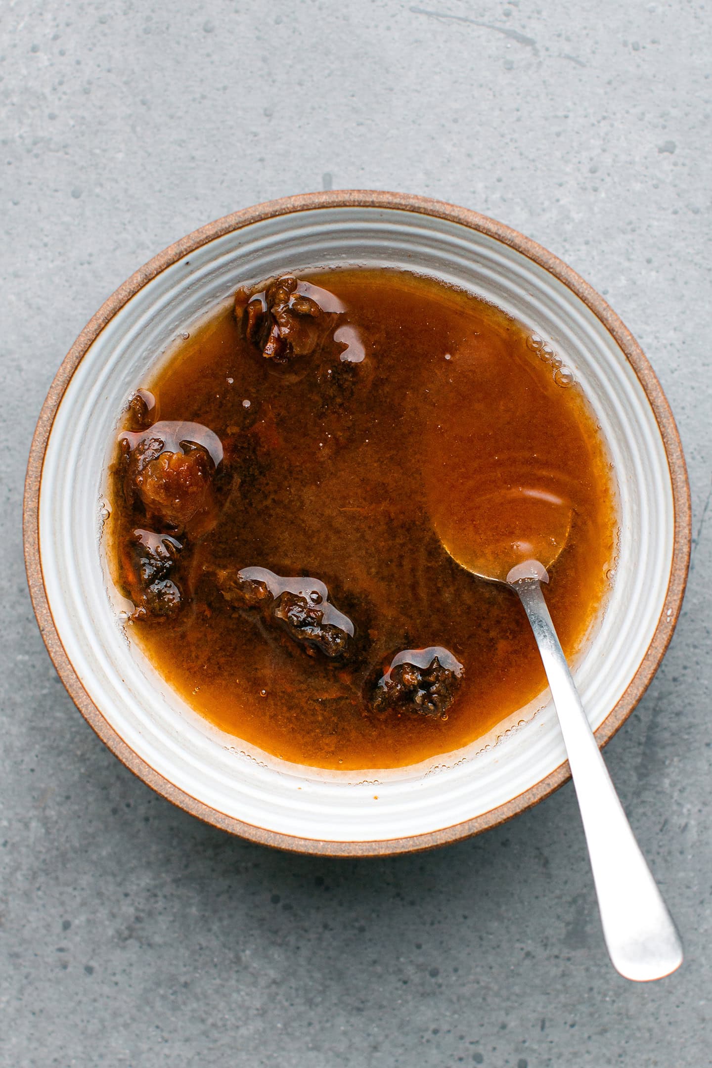 Tamarind paste and water in a bowl.