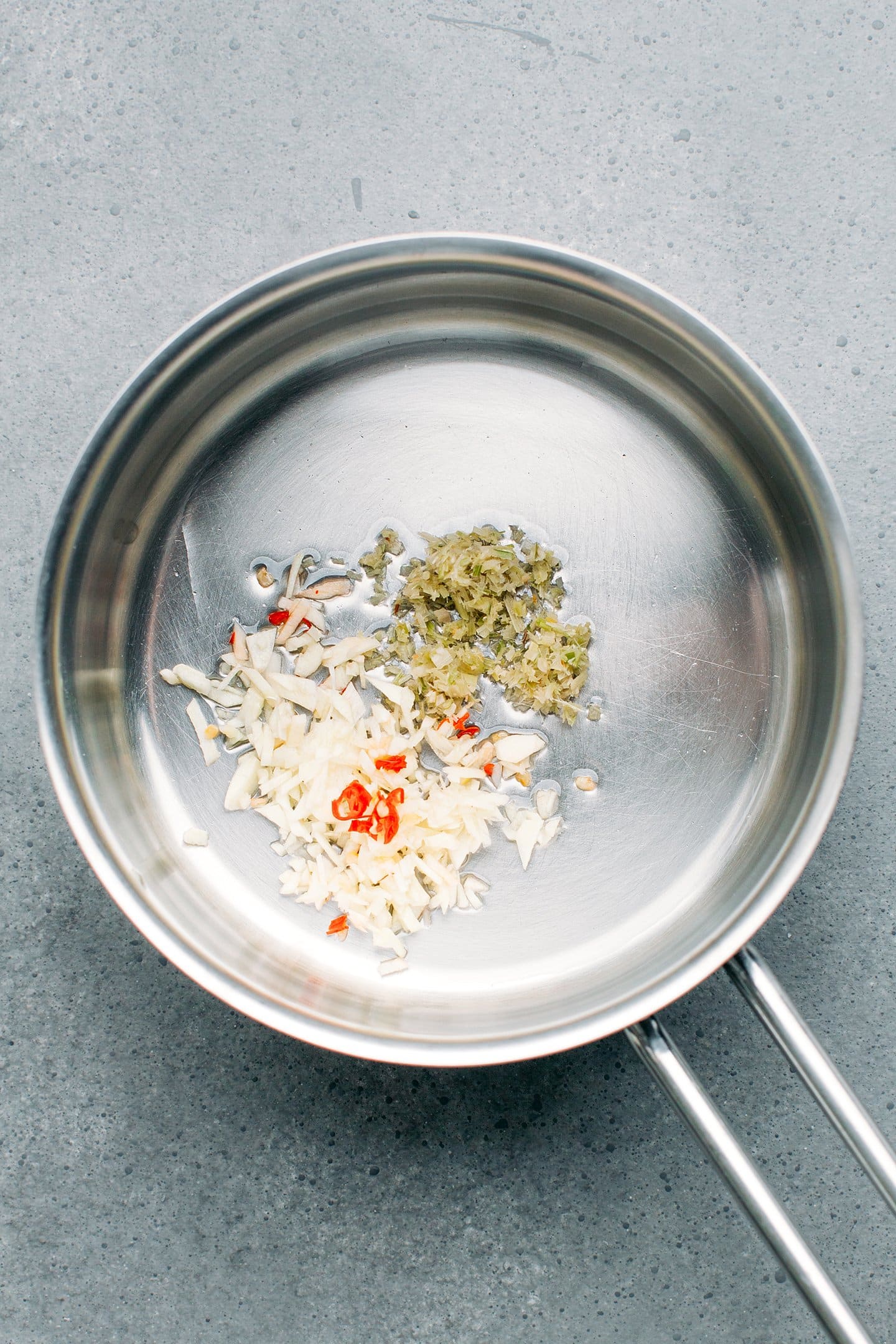 Minced garlic, lemongrass, and chili in a saucepan.