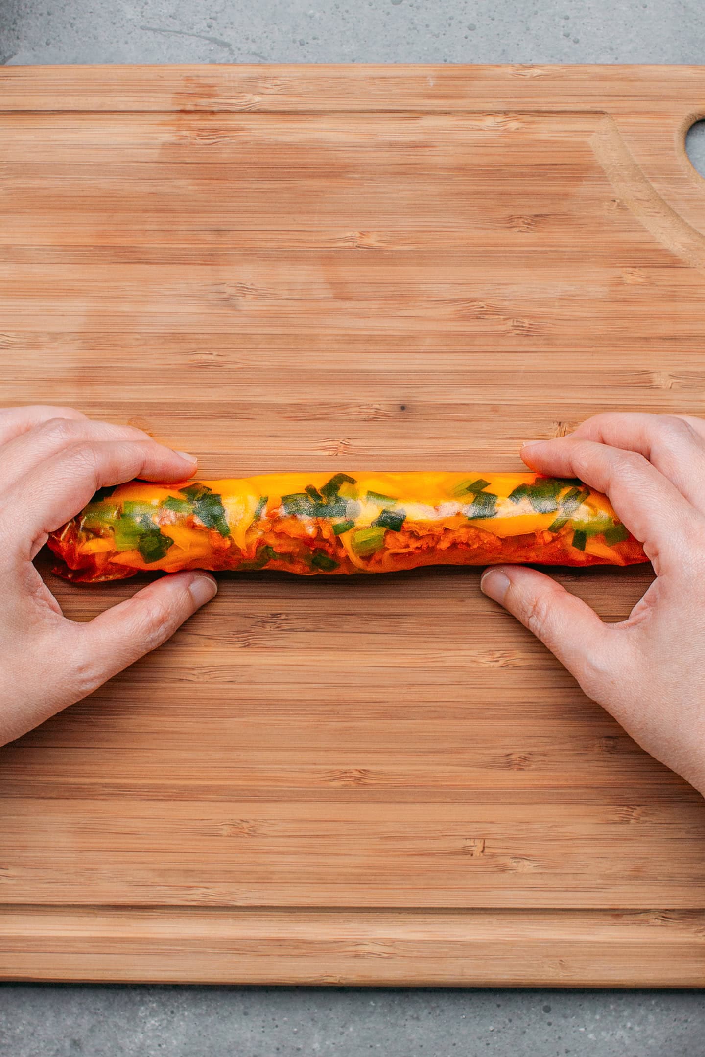 Rice paper roll filled with green onions, mango, and jackfruit.